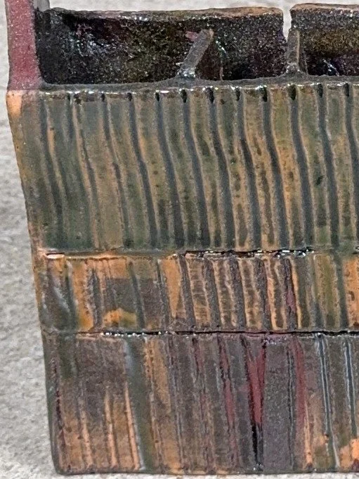 Close-up of Skyline 1, a red stoneware sculpture with orange decorating slip by ceramic Artist Cristina Lorenzet.