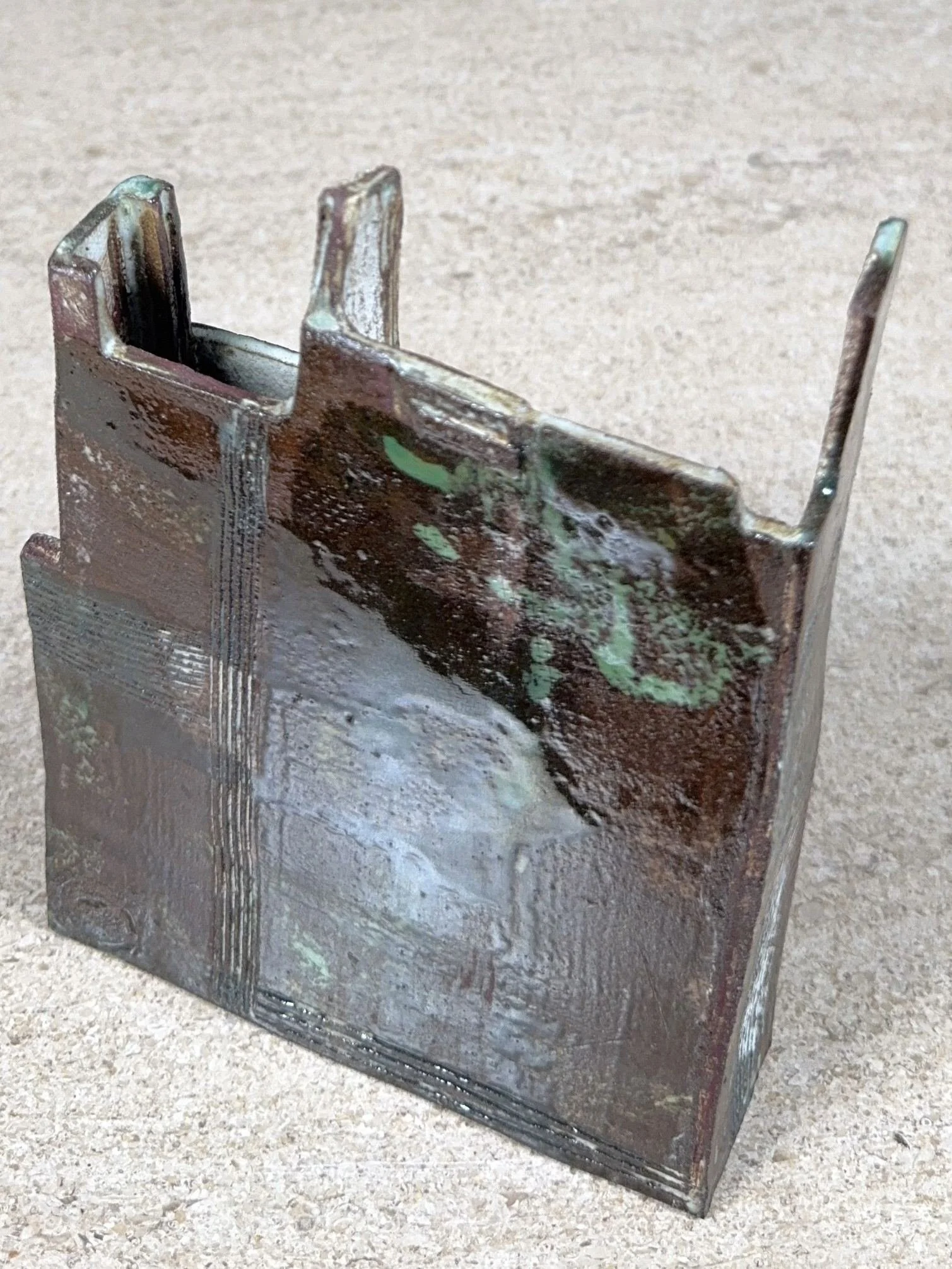 Back view of Skyline 2, a red stoneware sculpture by Artist Cristina Lorenzet decorated with white and green slips