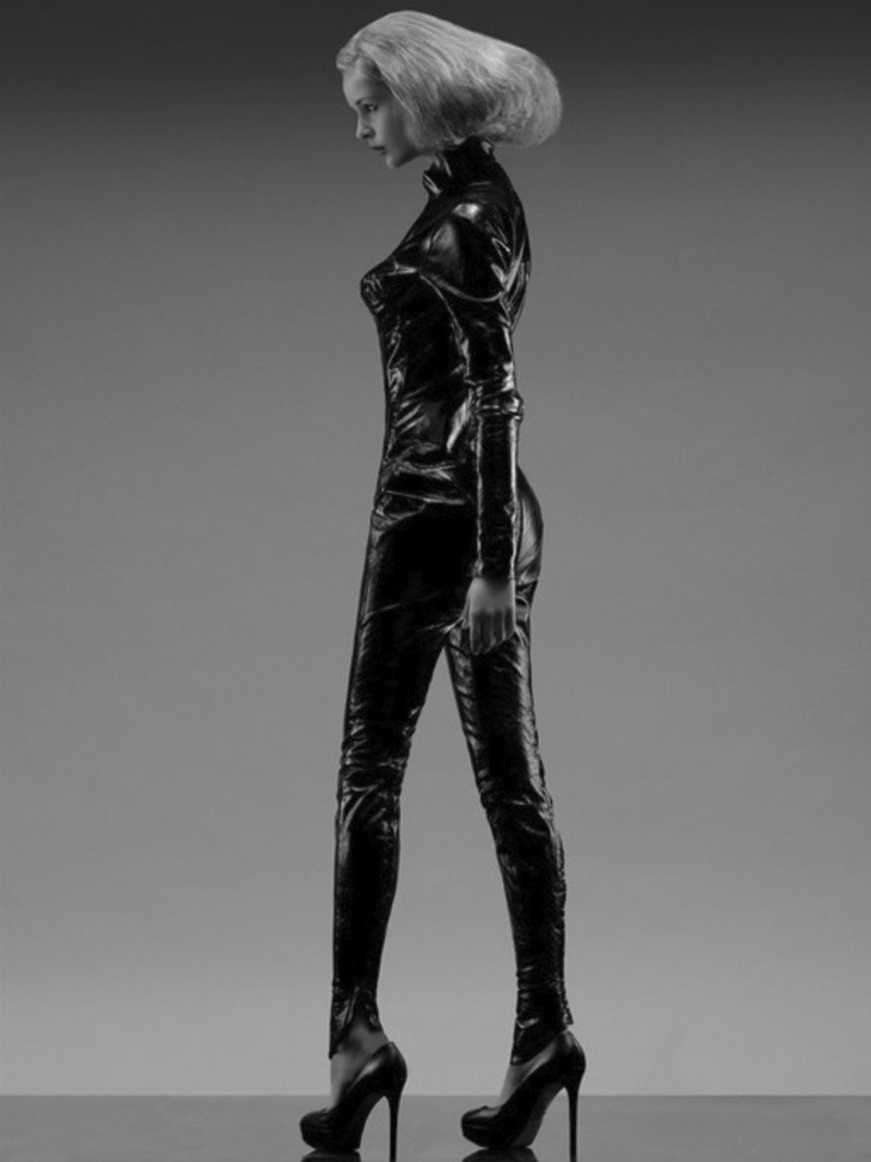 Girl in Latex, a photograph by Carlos Lumiere, standing model wearing black latex, sculptural footwear and a creative coiffure.