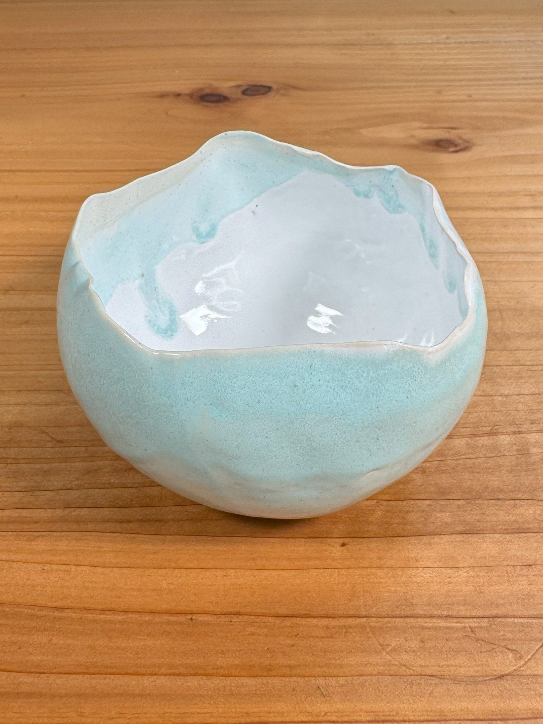 Medium raw-edged bowl by ceramic Artist Narain DeTar, Hand-built with white glaze inside and beautiful copper blue outside.