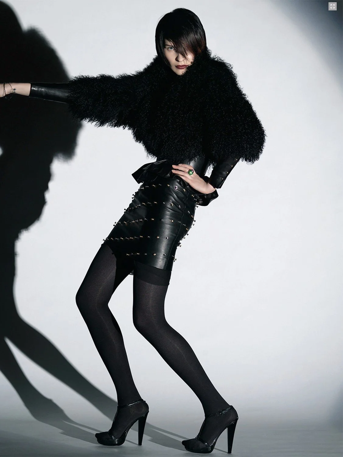 Not this way, a photograph by Carlos Lumiere, right side of image, from a Harper’s Bazaar shoot, leather, feathers and attitude.