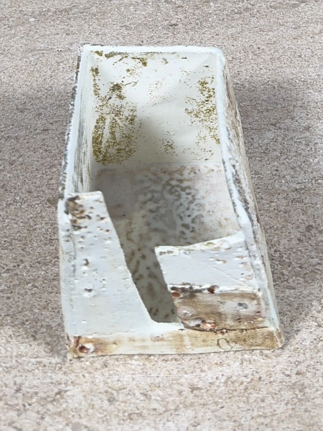 Patina on a building by ceramic Artist Cristina Lorenzet, white textured stoneware and porcelain sculpture, front top view.