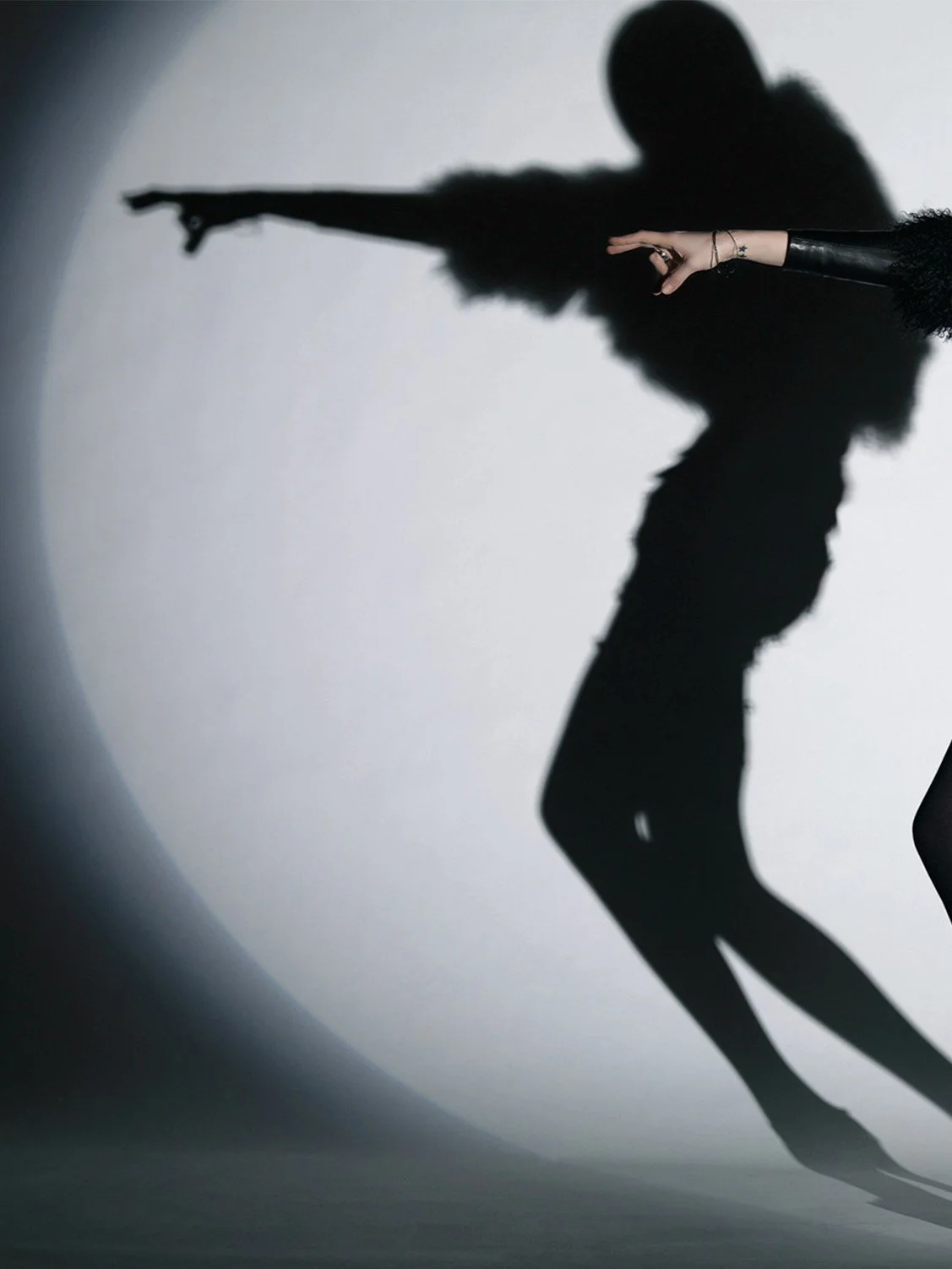 Not this way, a photograph by Carlos Lumiere, left side of image, from a Harper’s Bazaar shoot, leather, feathers and attitude.