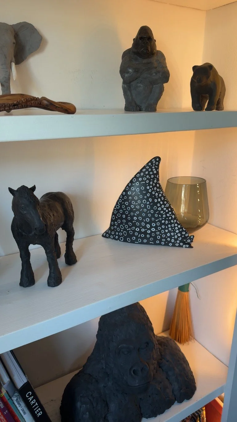 Half Wing Eagle Ray sculpture by Julien Hipeau, cast in Jesmonite, displayed on a shelf alongside other sculptures.