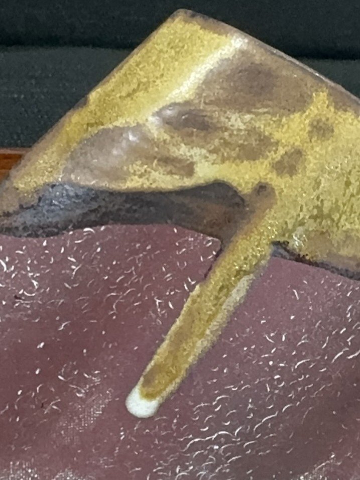 Close-up of Rooftile fragment 1 by ceramic Artist Cristina Lorenzet, an original undulating red stoneware sculpture.