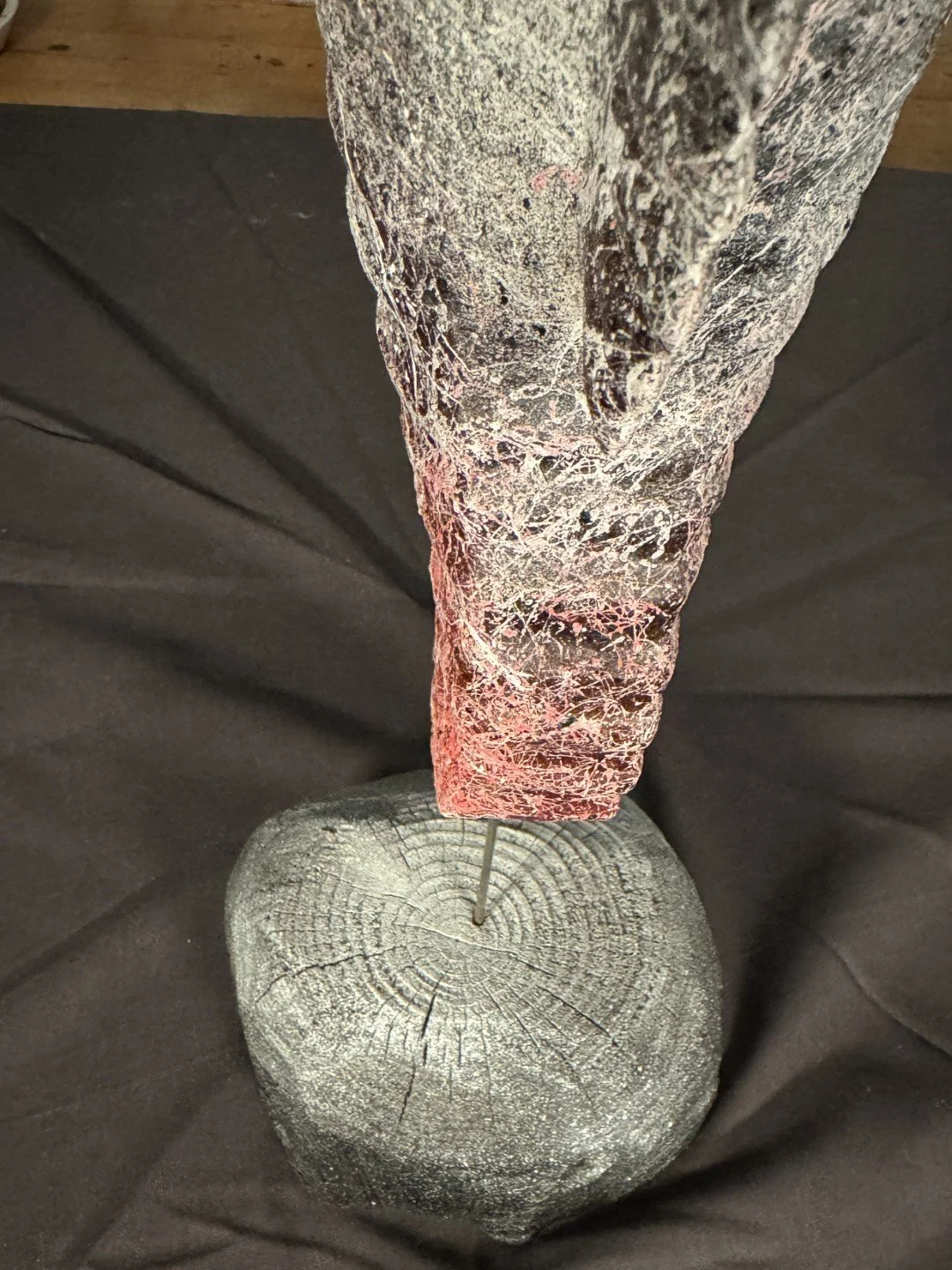 Seahorse sculpture by Artist Julien Hipeau, stand closeup view, cast of a charred wooden seahorse, with grain and texture.