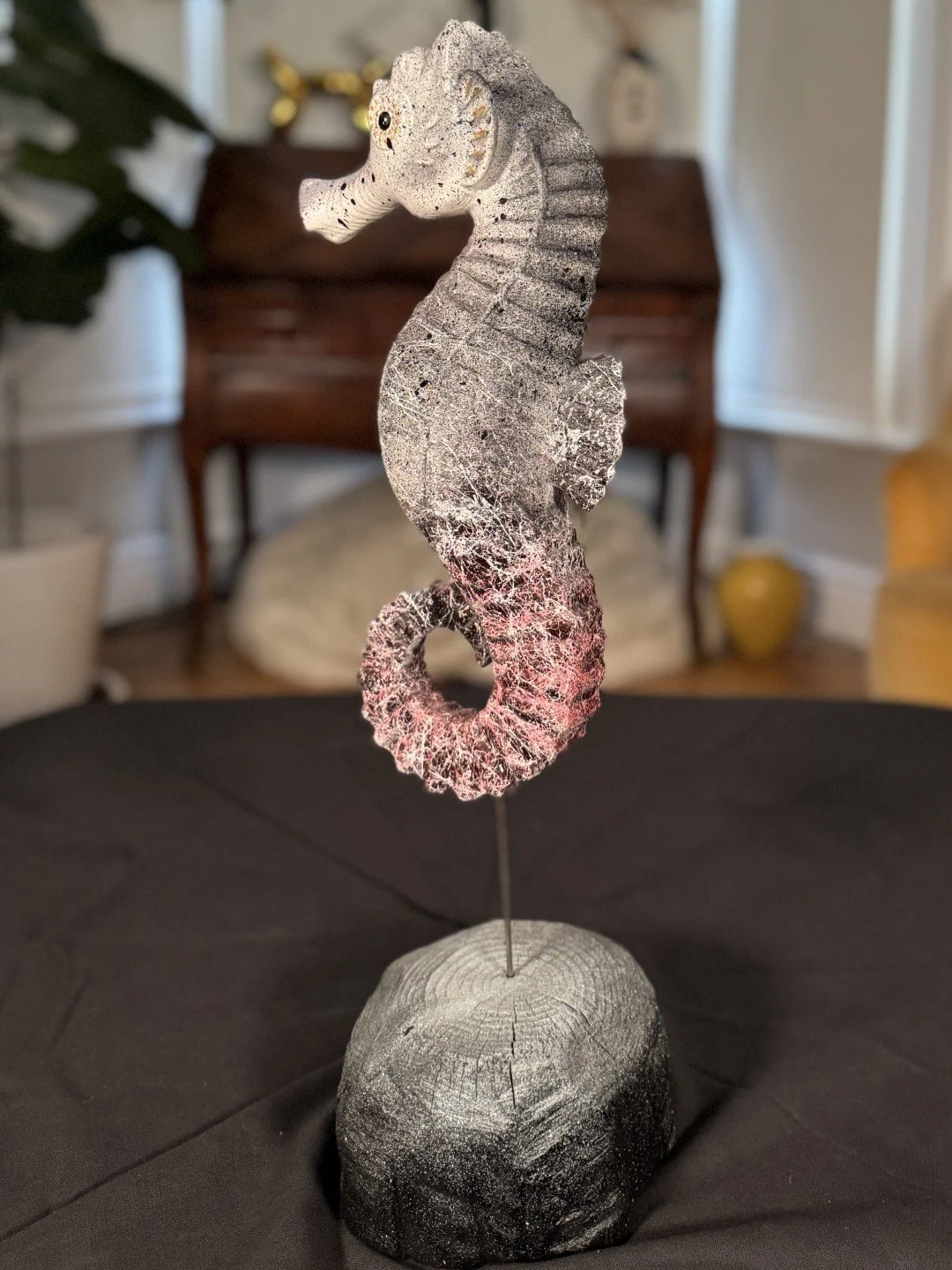 Seahorse sculpture by Artist Julien Hipeau, side view, cast of a charred wooden seahorse, with grain and texture.