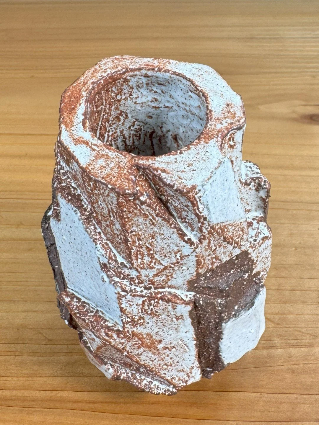 close-up view of Kurinuki vase by ceramic Artist Nupur Narain DeTar, hand-carved, glazed and high-fired.