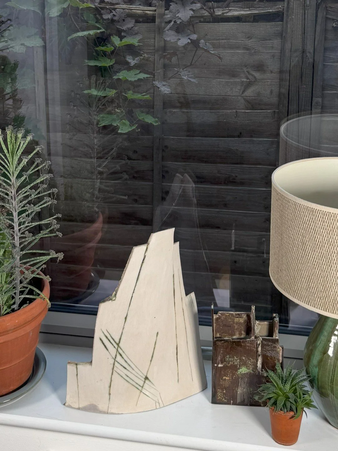 London Façade 1 by ceramic Artist Cristina Lorenzet, a unique white stoneware sculpture displayed with other artwork.