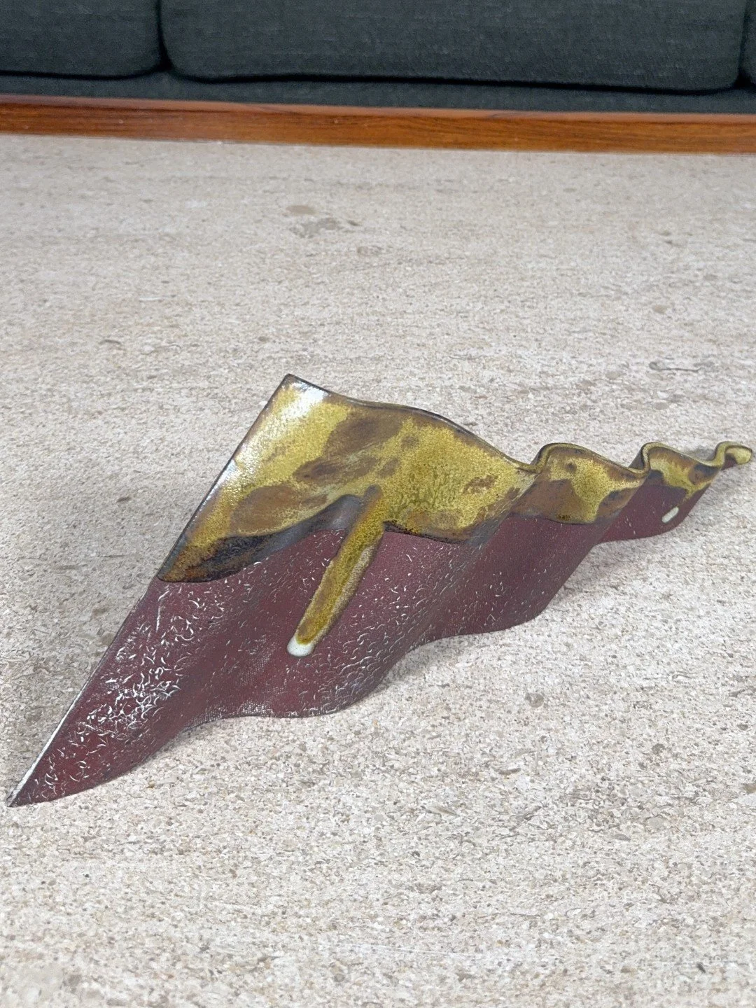 Rooftile fragment 1 by Artist Cristina Lorenzet is a red stoneware sculpture partially decorated with an iron-rich glaze.