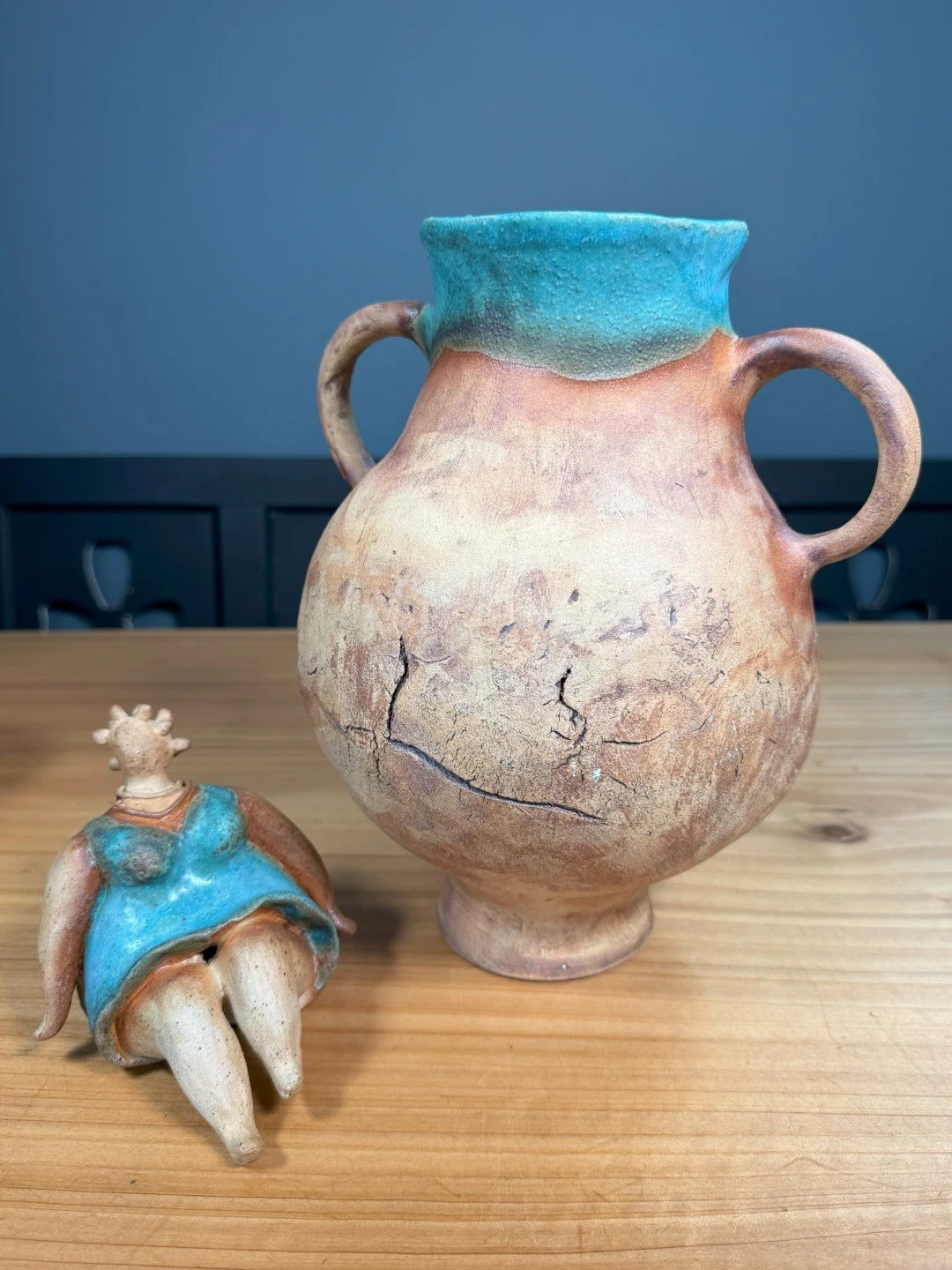 Large hand-crafted ceramic vase by Artist Nupur Narain DeTar, displayed with sitting lady in dress sculpture.