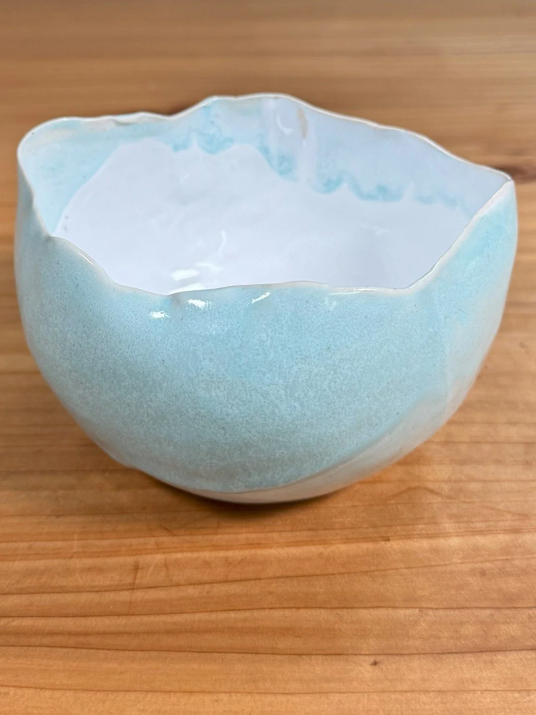Medium raw-edged bowl by Artist Nupur Narain DeTar, Hand-built, high-fired with white glaze inside and copper blue outside.