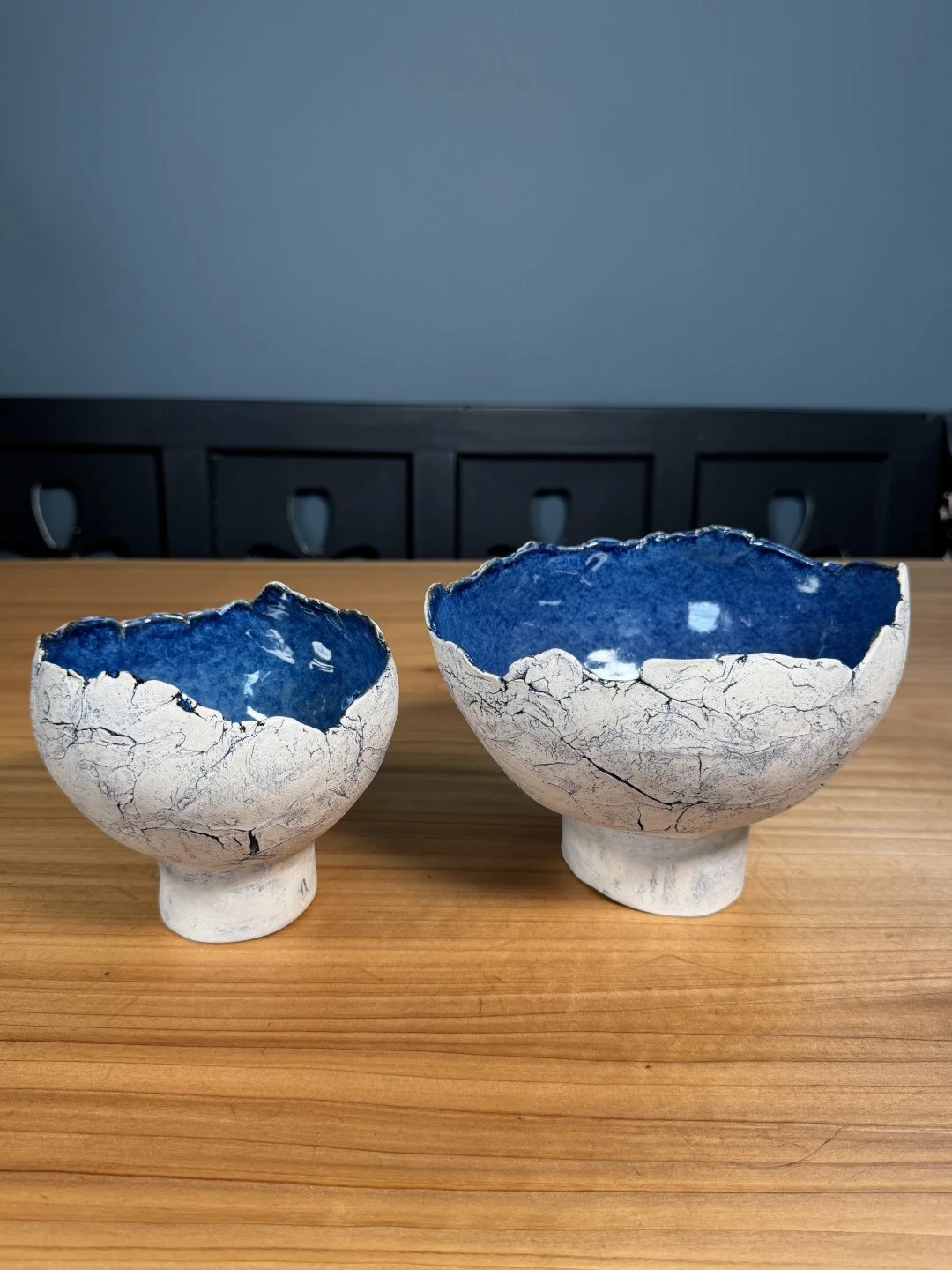 Hand-crafted large and medium crackle bowls with pedestal by ceramic Artist Nupur Narain DeTar, with beautiful blue pigments.