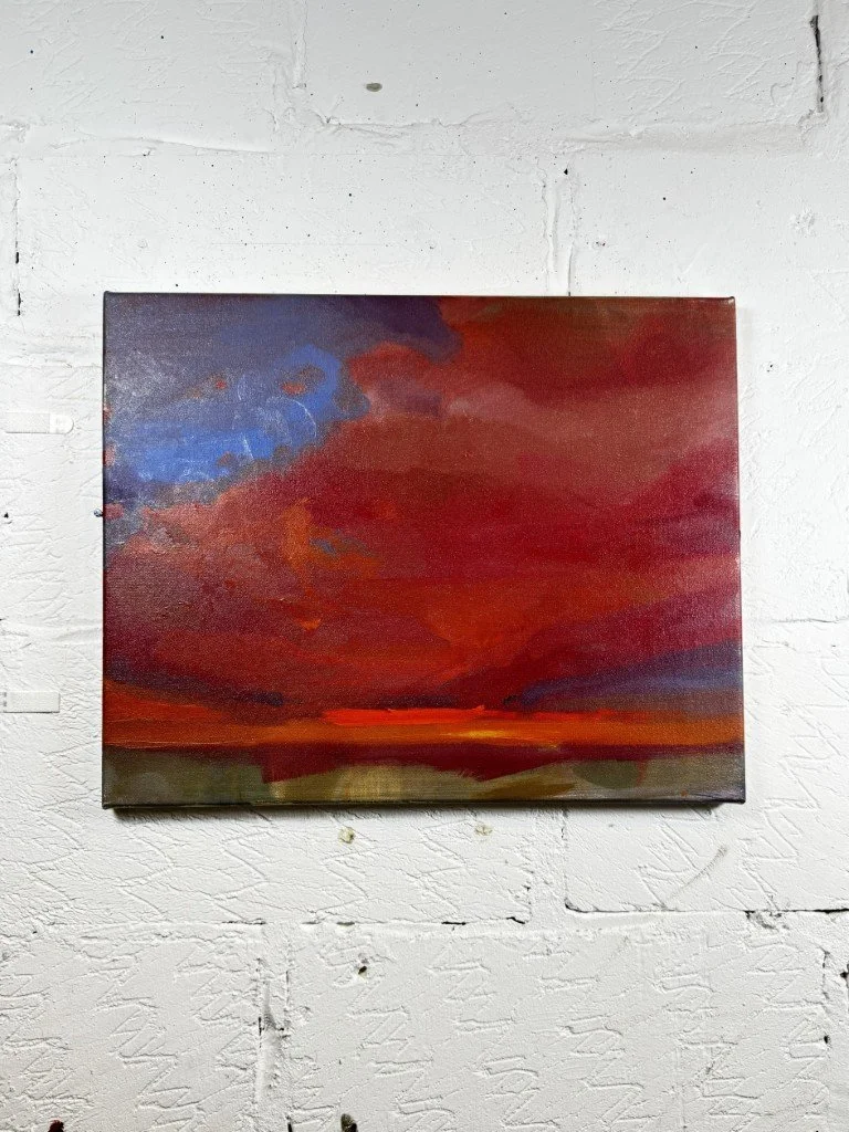 Oil painting capturing a dramatic crimson red and dark purple sunset sky over Cape Town by Larissa Hollis, displayed on wall.