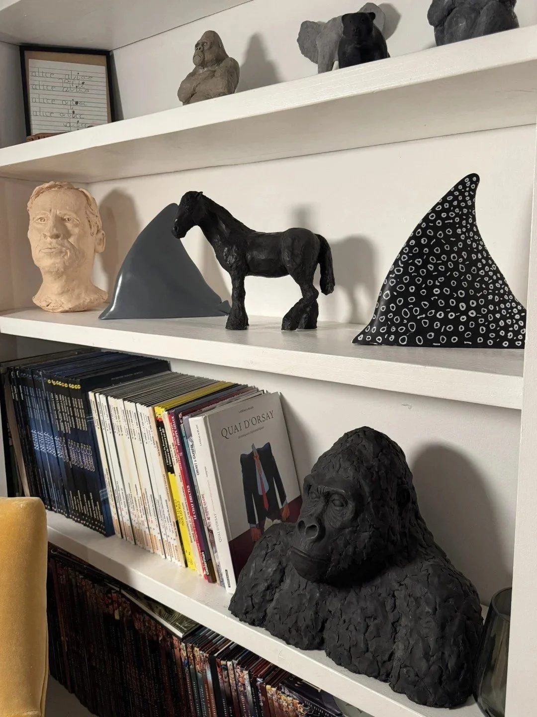 Gorilla Bust, a sculpture by Artist Julien Hipeau, cast in Jesmonite, displayed on bookshelves with other artworks.