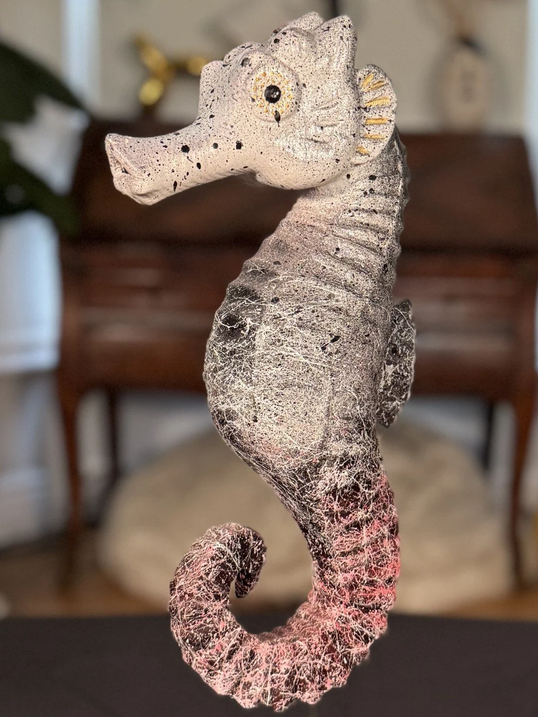 closeup of Seahorse sculpture by Artist Julien Hipeau, a jesmonite cast of a charred wooden seahorse, with grain and texture.