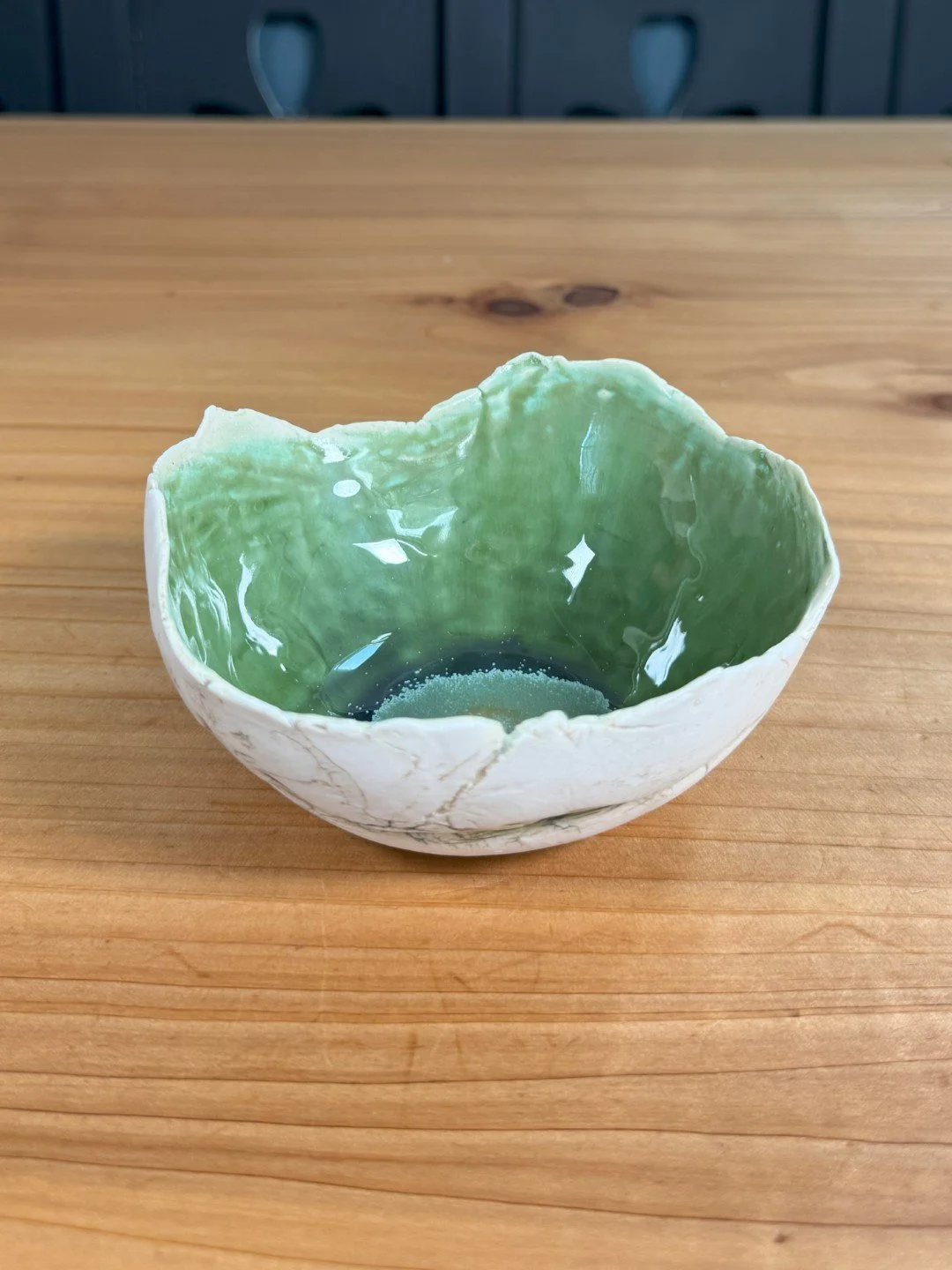 Small rough-edged bowl by ceramic Artist Nupur Narain DeTar, hand-built, with beautiful green high-fired food-safe glaze.