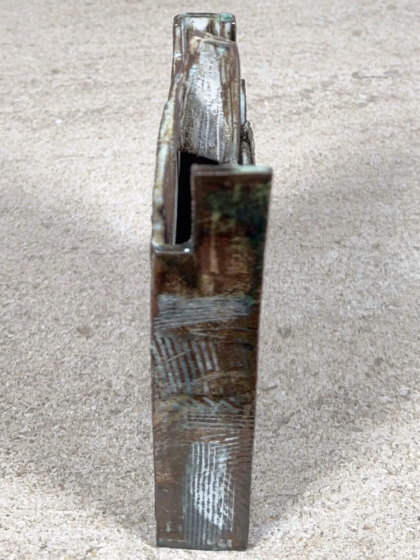 Side view of Skyline 2, a red stoneware sculpture by Artist Cristina Lorenzet decorated with white and green slips