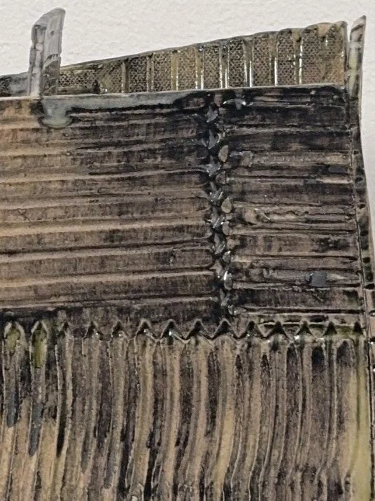 Close-up of white stoneware sculpture Skyline 3 by ceramic Artist Cristina Lorenzet, decorated with black underglaze wash.