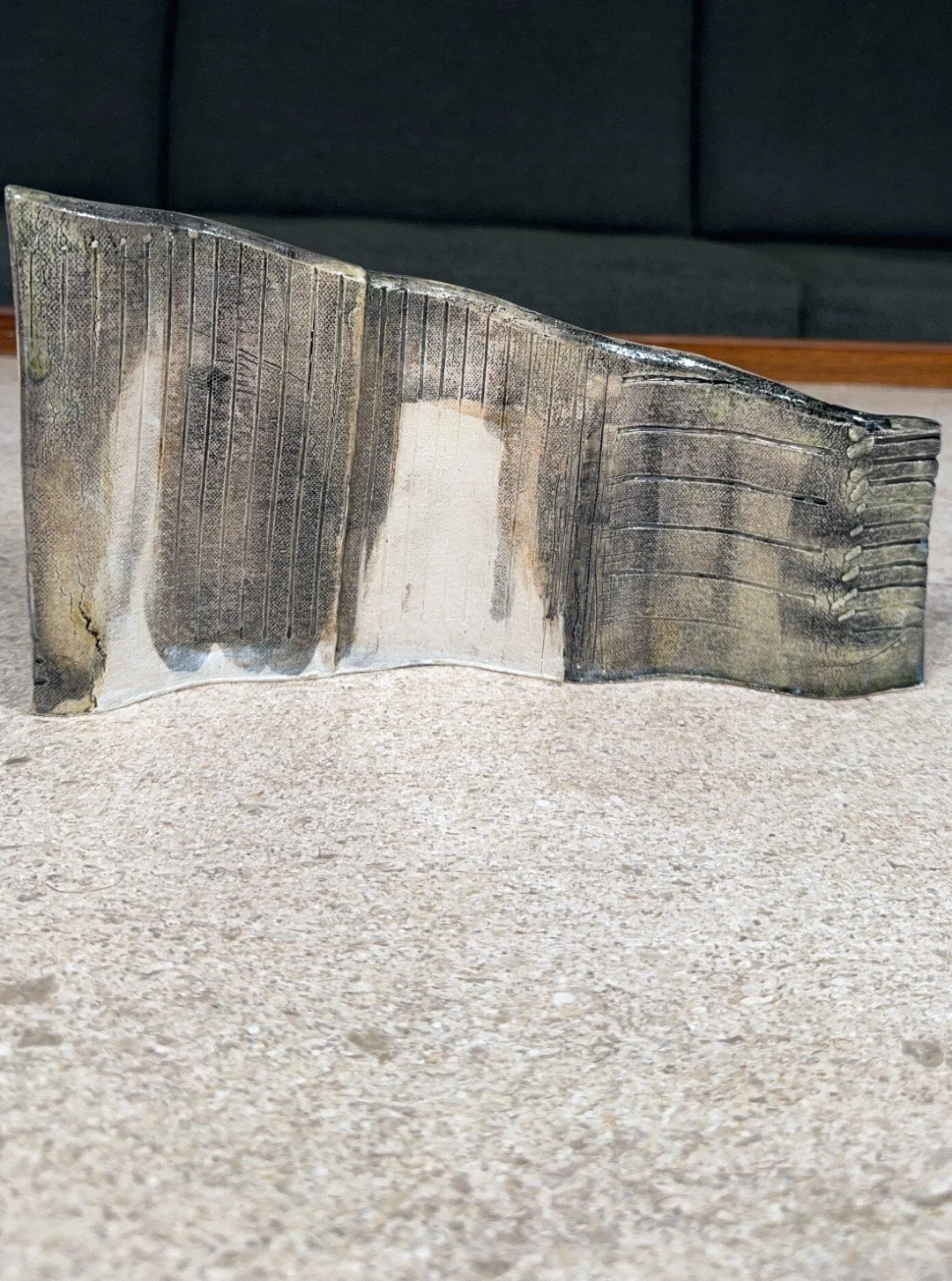 Rooftile fragment 2 sculpture by ceramic Artist Cristina Lorenzet is decorated with an iron-rich glaze and black underglaze.