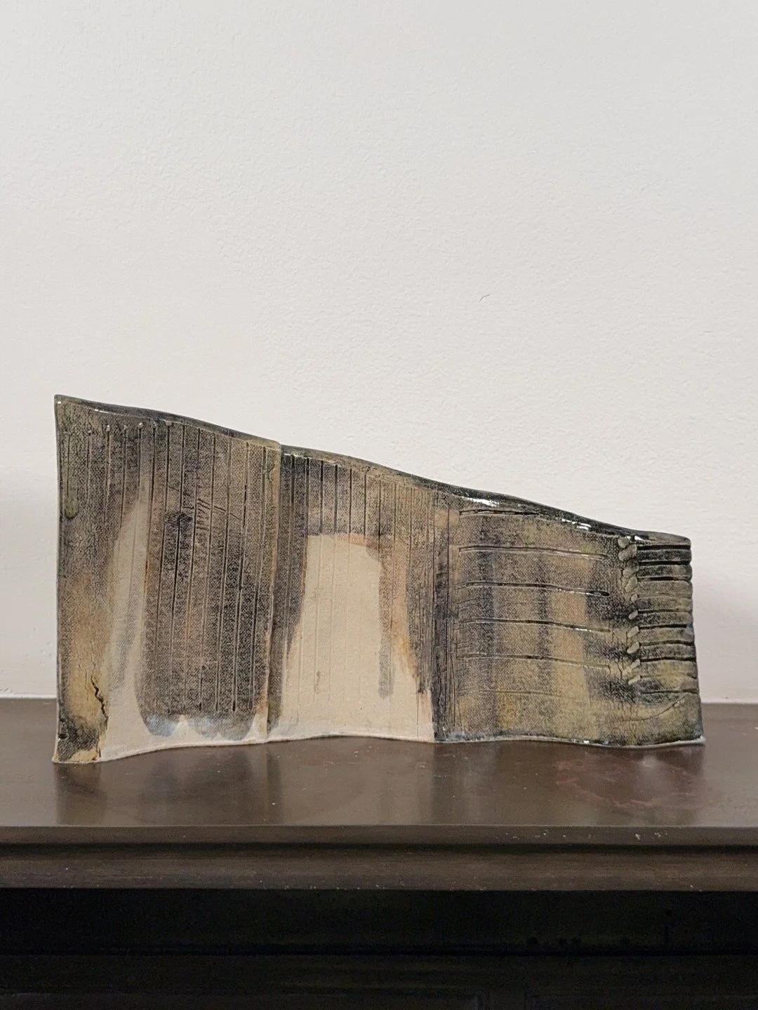 Rooftile fragment 2 by ceramic Artist Cristina Lorenzet is a handmade undulating white stoneware sculpture.