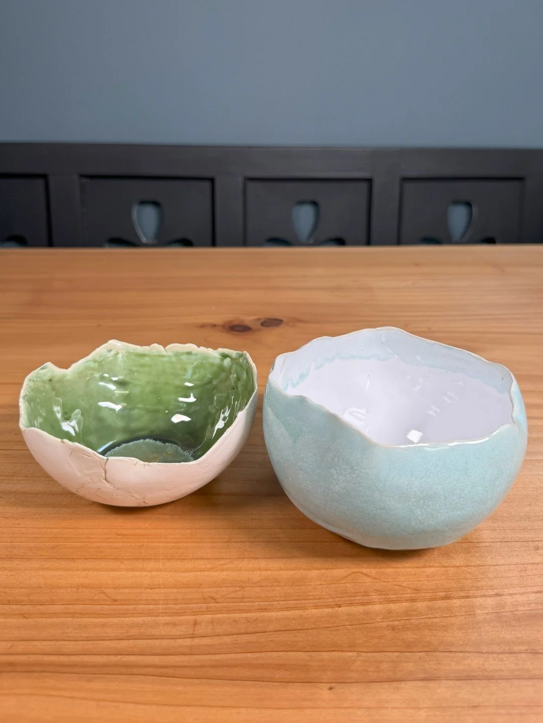 Small rough-edged bowl by ceramic Artist Nupur Narain DeTar, hand-built, displayed with copper blue medium bowl.