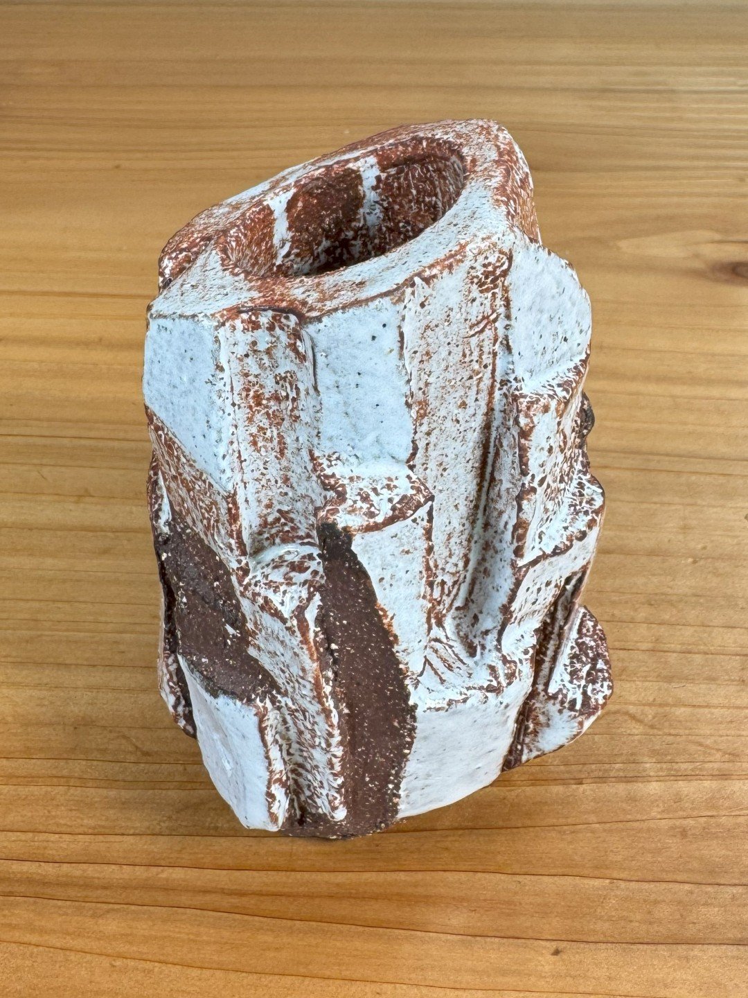 Side view of Kurinuki vase by ceramic Artist Nupur Narain DeTar, hand-carved, glazed and high-fired.