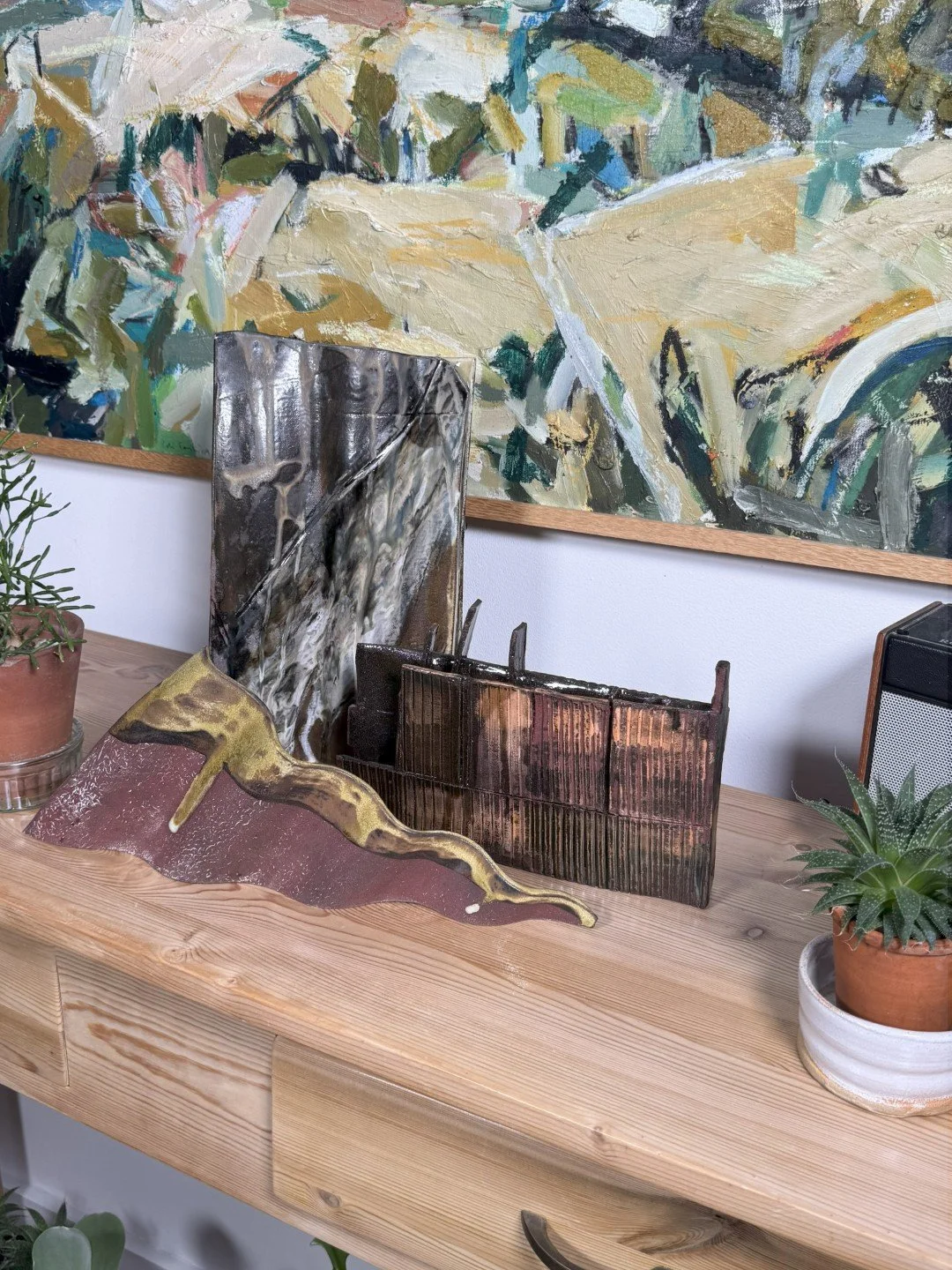 Rooftile fragment 1 sculpture by ceramic Artist Cristina Lorenzet displayed on a side table with other sculptures.