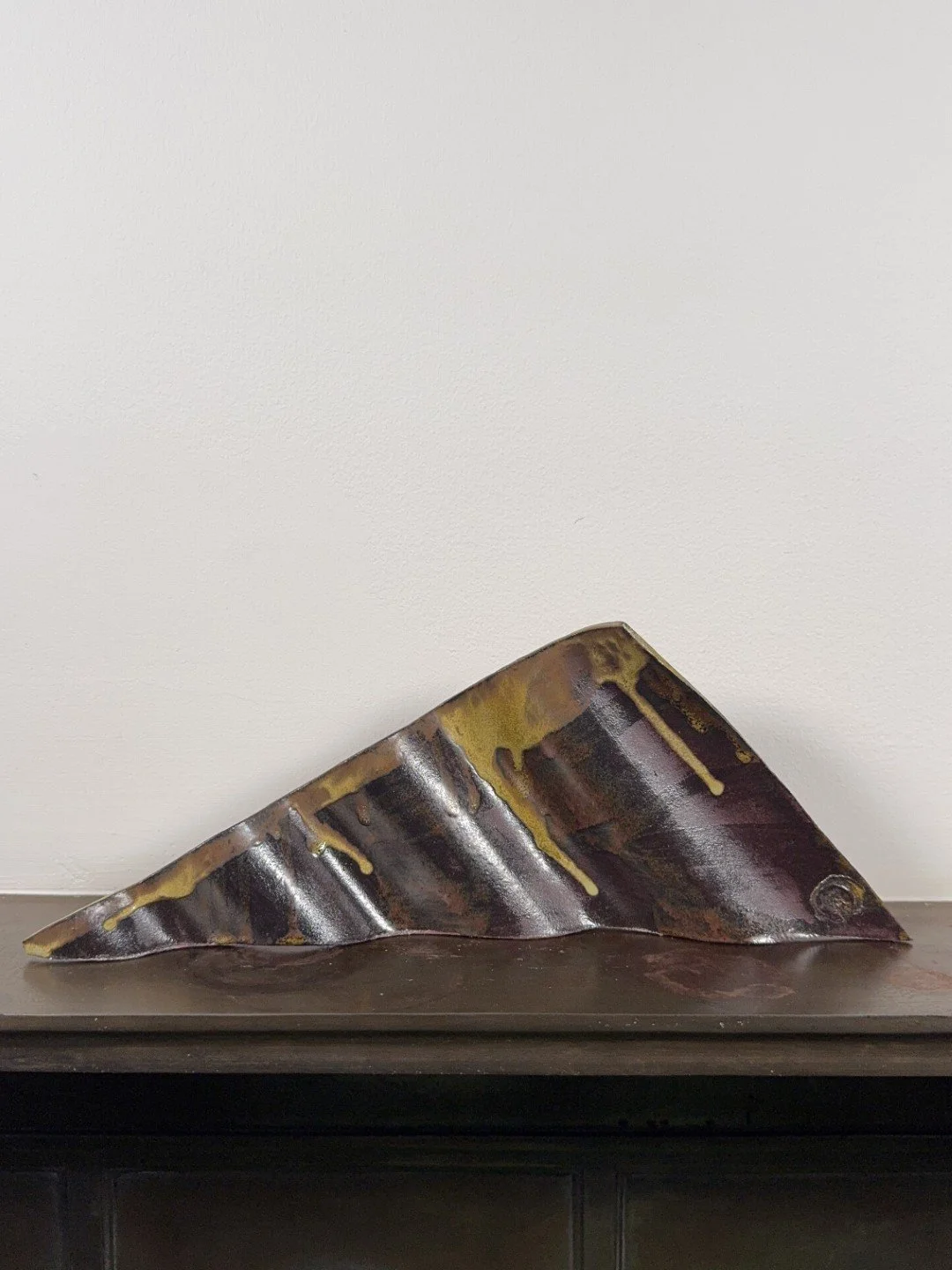 Rooftile fragment 1 by ceramic Artist Cristina Lorenzet is an original undulating red stoneware sculpture.