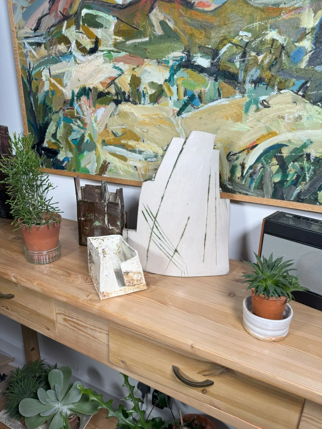 Patina on a building by ceramic Artist Cristina Lorenzet, stoneware and porcelain sculpture, viewed with other artworks.