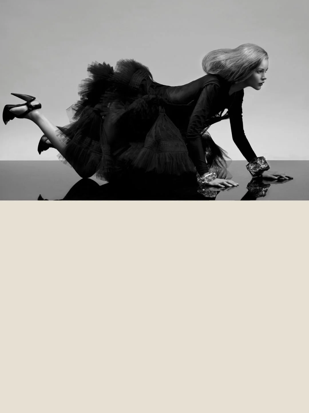 Miaouu, a photograph by Carlos Lumiere, the model on hands and knees is styled with a glamourous black dress and jewellery.