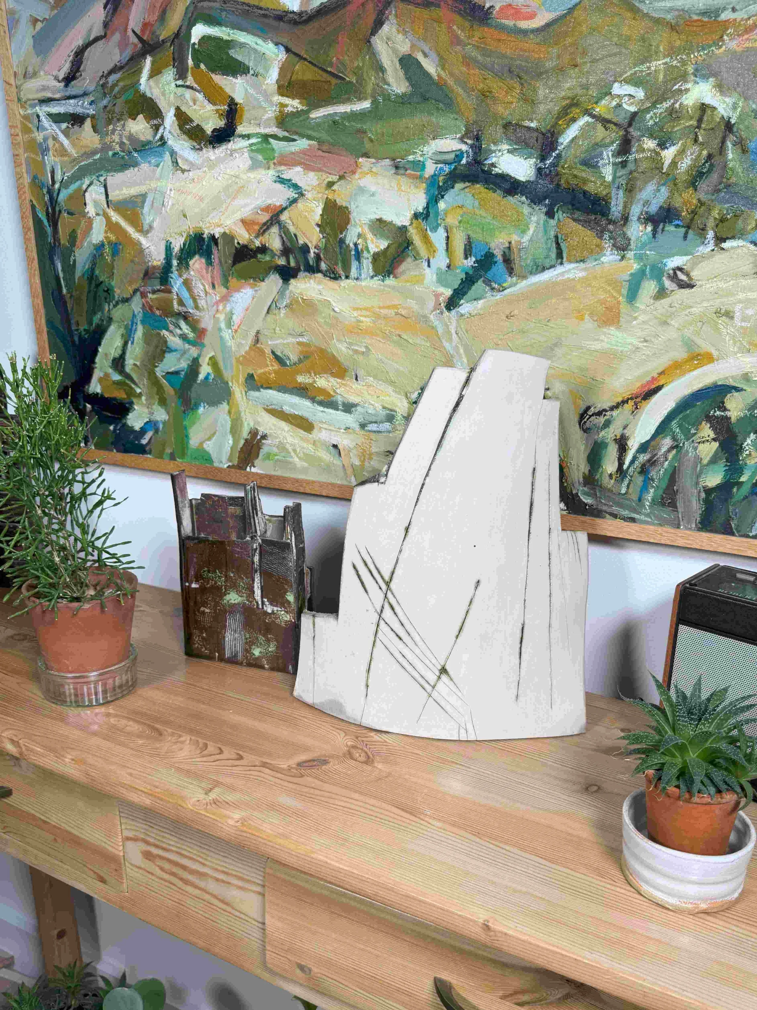 Red stoneware sculpture Skyline 2 by Artist Cristina Lorenzet displayed with other sculpture London Façade 1 on a table