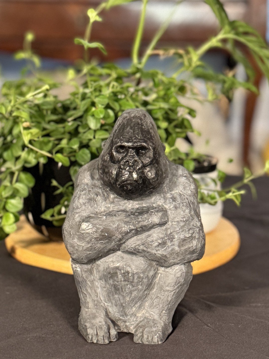 Seated Silverback sculpture by Artist Julien Hipeau, in front of plant pot, inspired by the French artist E. Aubry.