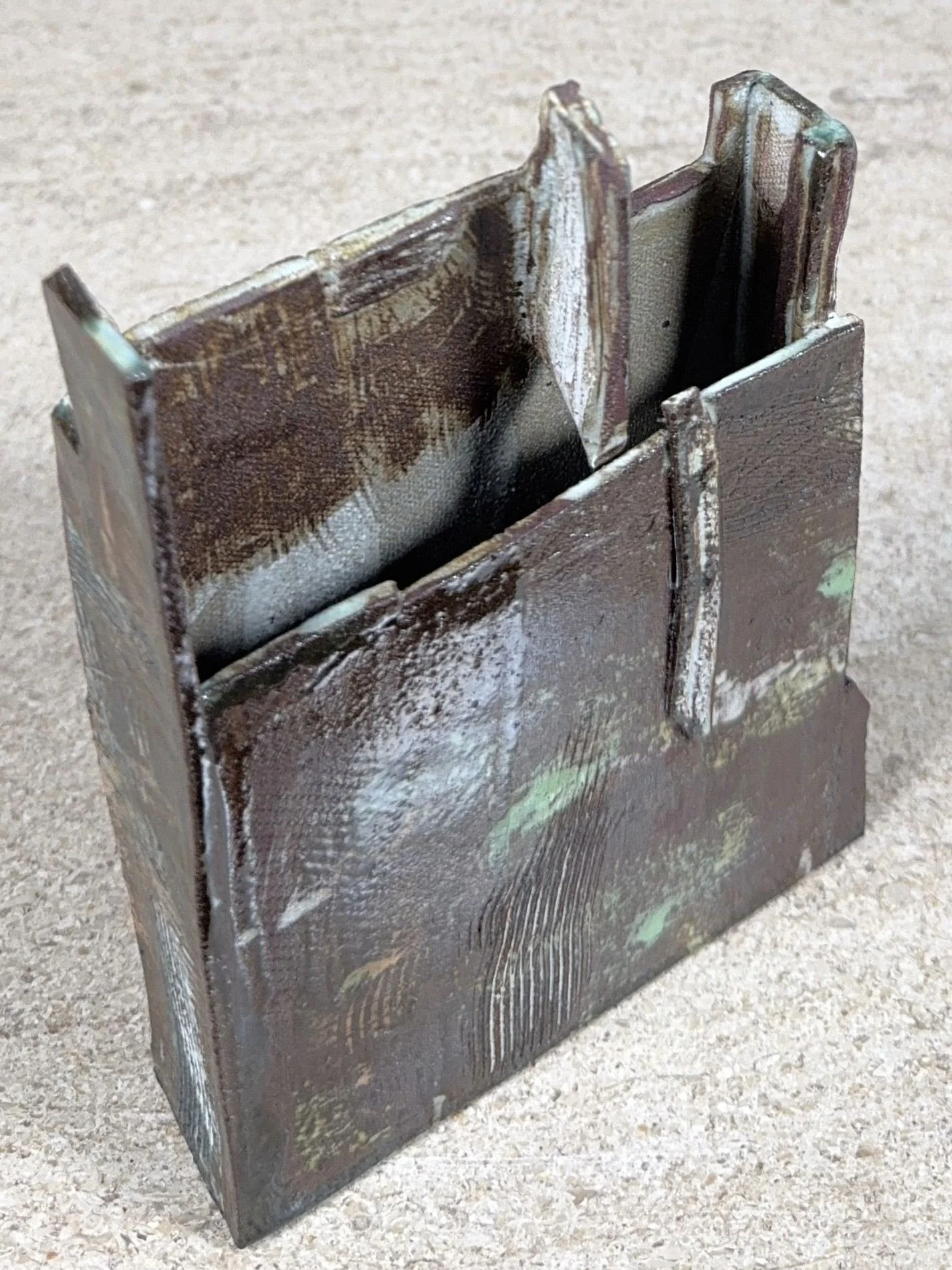 Top side view of Skyline 2, a red stoneware sculpture by Artist Cristina Lorenzet decorated with white and green slips