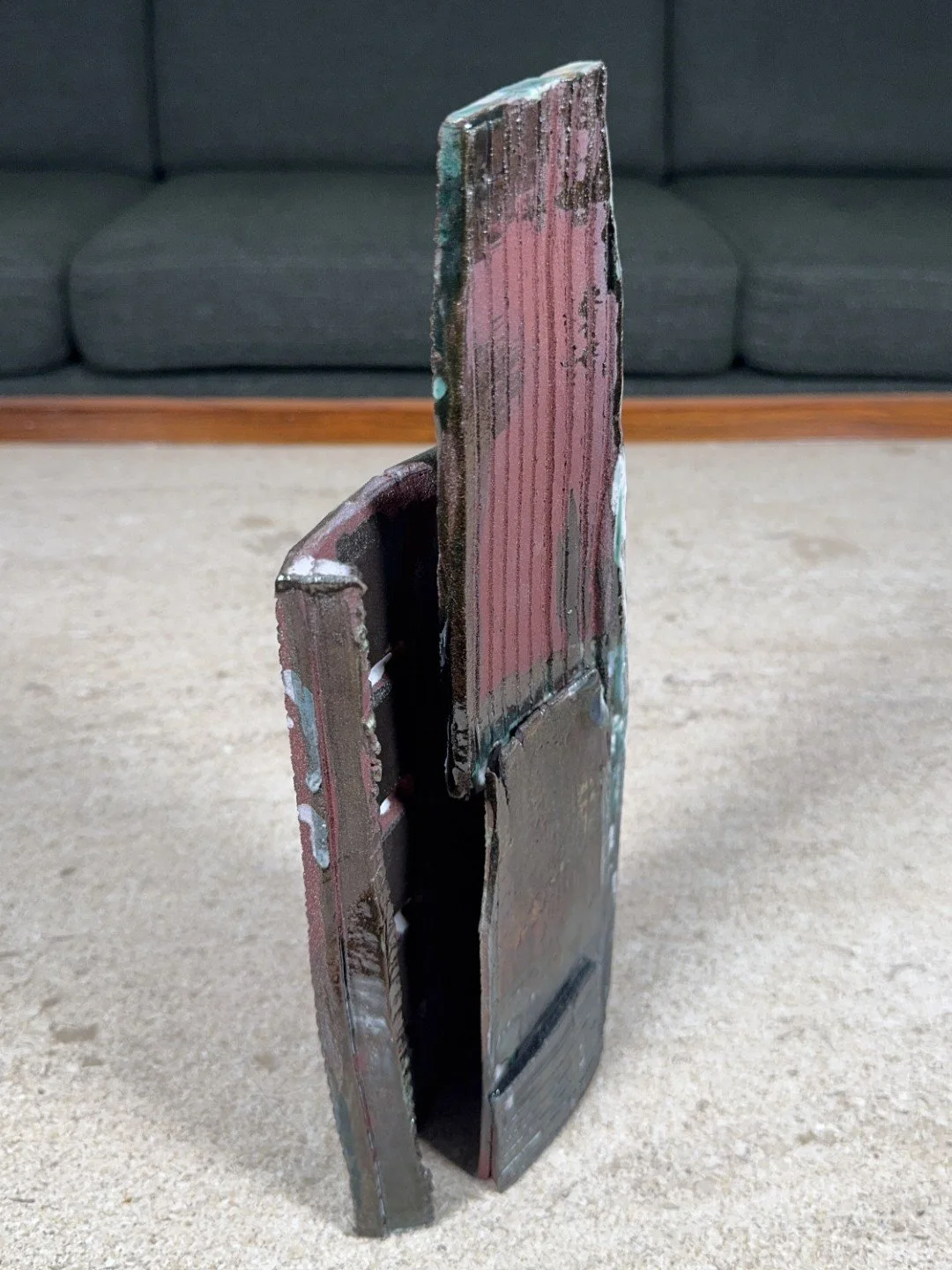 Side and back view of Skyline 4 by ceramic Artist Cristina Lorenzet, a red stoneware sculpture with different textures.