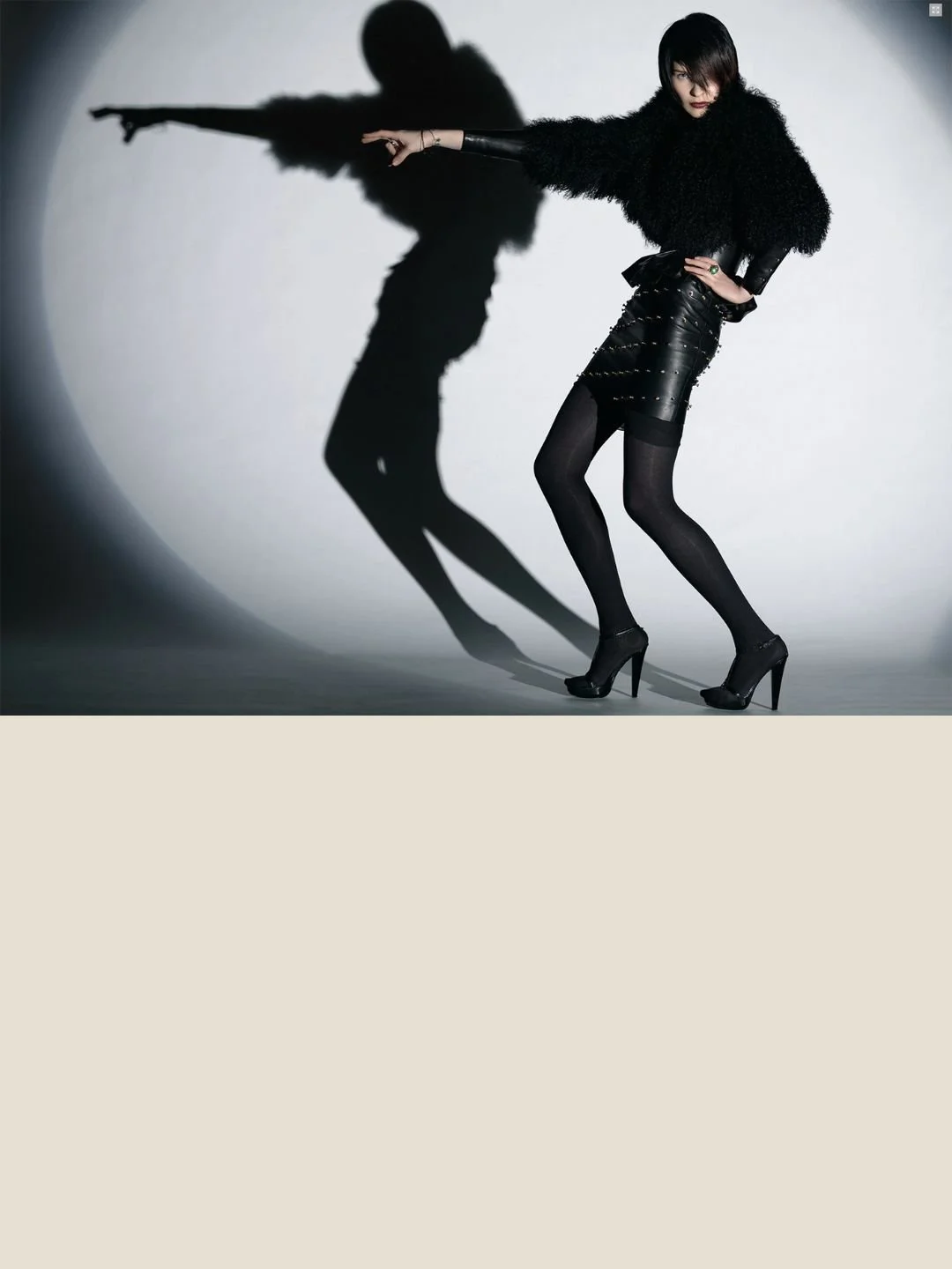 Not this way, a photograph by Carlos Lumiere, from a Harper’s Bazaar editorial shoot, leather, feathers and attitude, 2007.