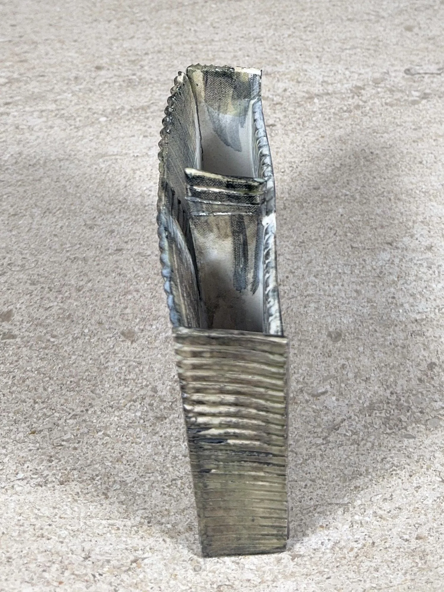 White stoneware sculpture Skyline 3 by ceramic Artist Cristina Lorenzet, viewed from the side.