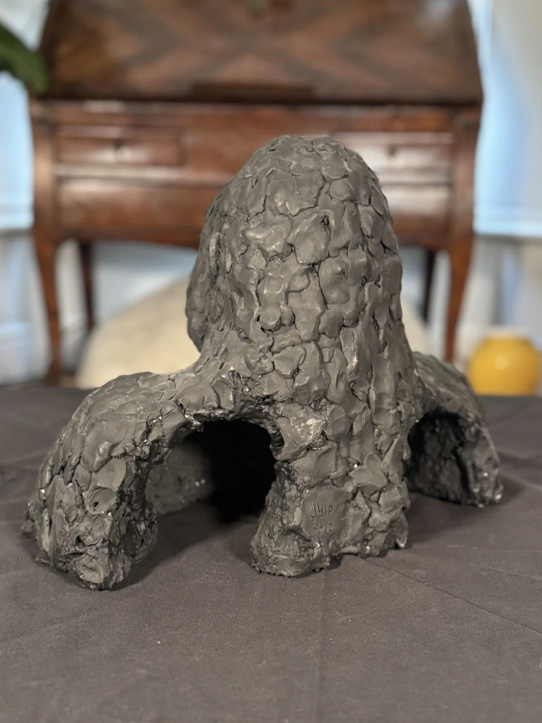 Gorilla Bust, a sculpture by Artist Julien Hipeau, cast in Jesmonite, displayed on coffee table and shown from the back.