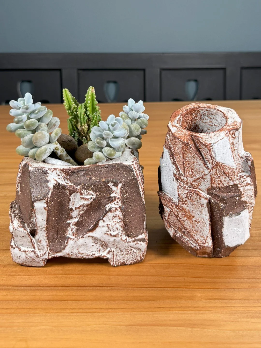Kurinuki planter with succulents by ceramic Artist Nupur Narain DeTar, hand-carved, displayed next to Kurinuki vase.