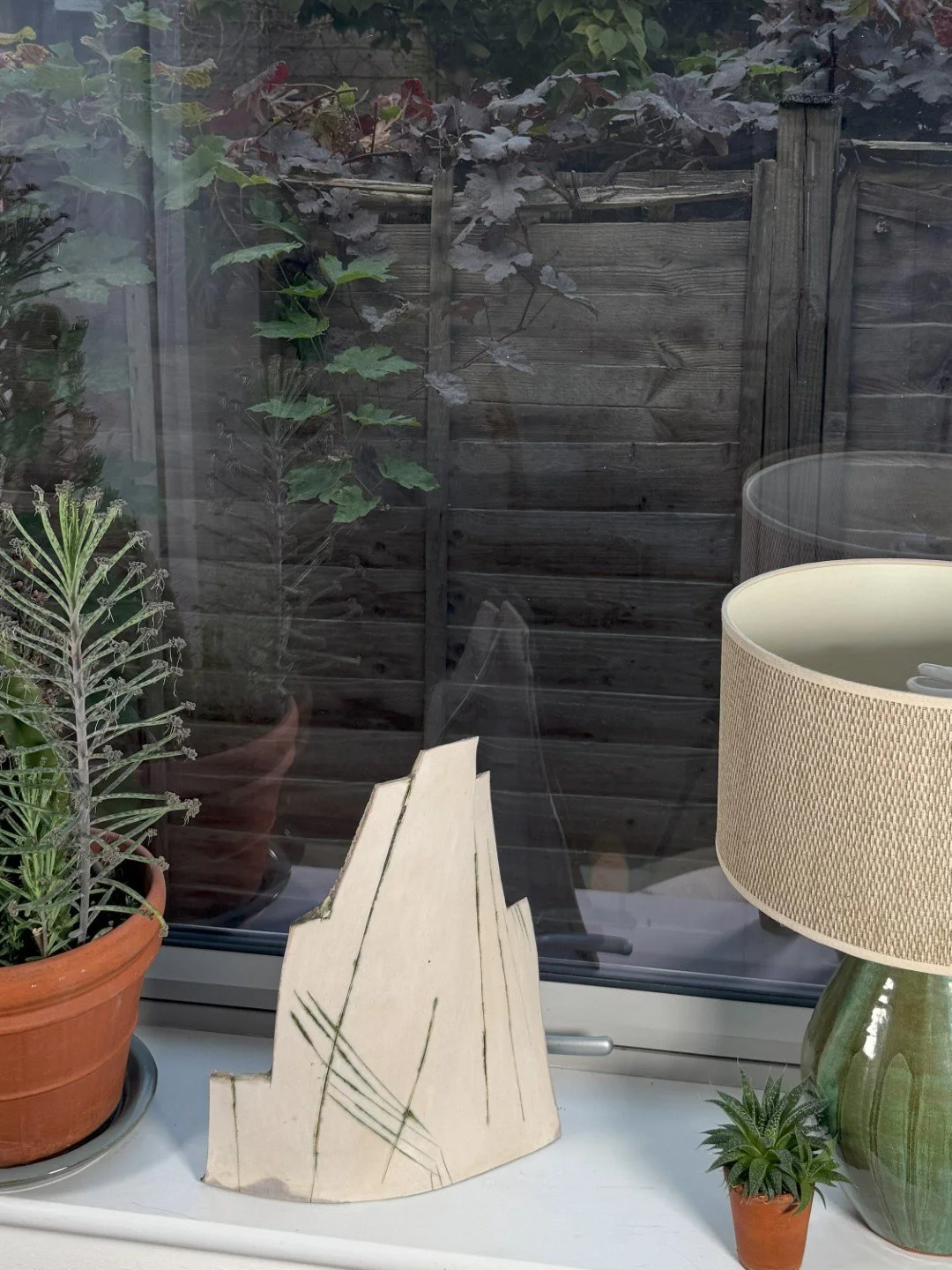 London Façade 1 by ceramic Artist Cristina Lorenzet, a unique contemporary white stoneware sculpture displayed on windowsill.