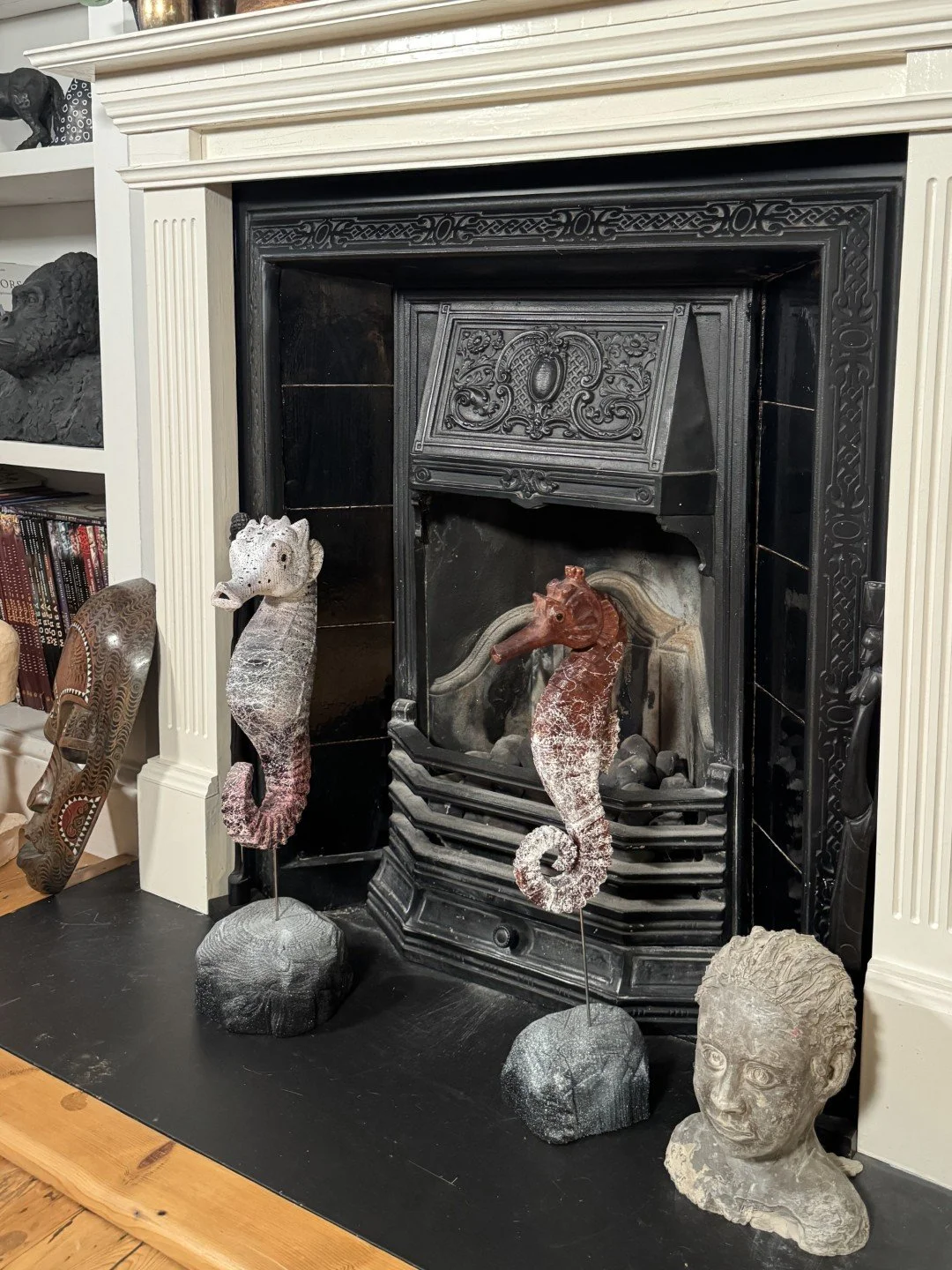Seahorse sculpture by Artist Julien Hipeau, displayed with other artwork Skinny Seahorse in front of a fireplace.
