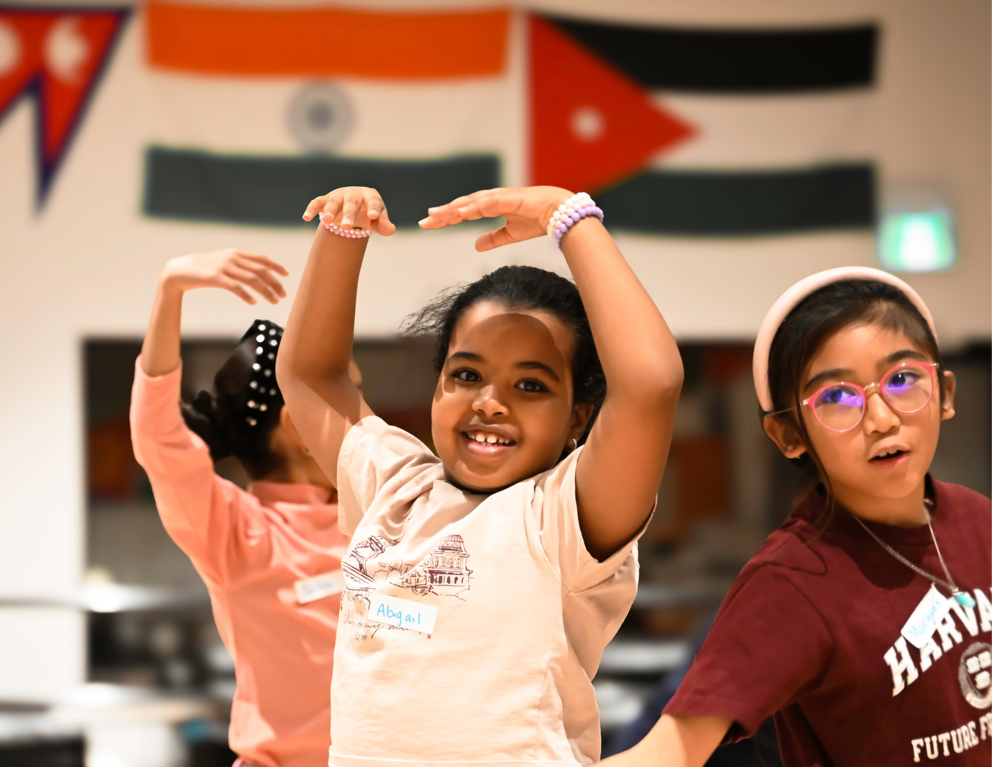 Three girls practicing ballet moves in the youth centre at CFN