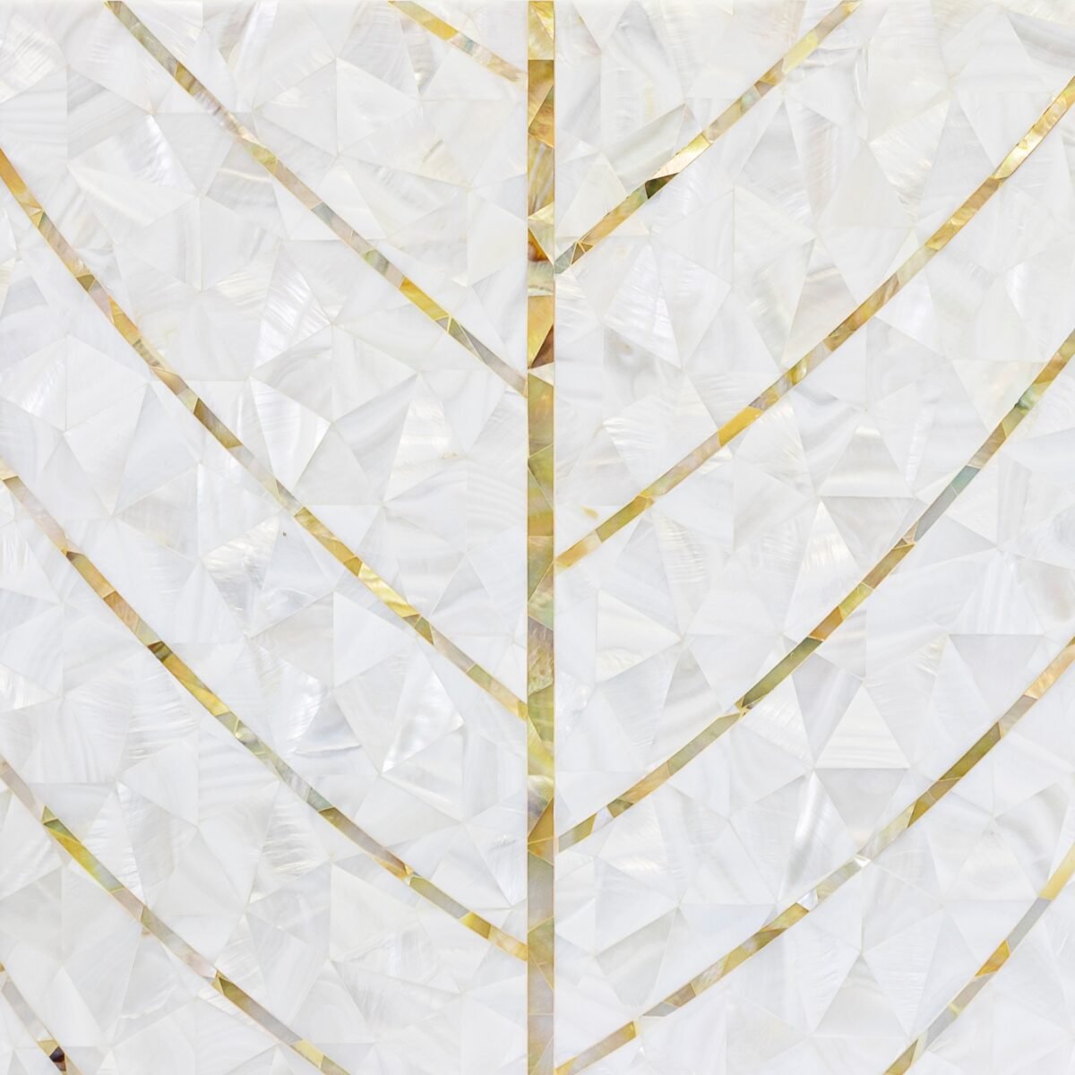 Close-up of a geometric pattern made of pearlescent white and gold-colored angular pieces arranged in symmetrical design.
