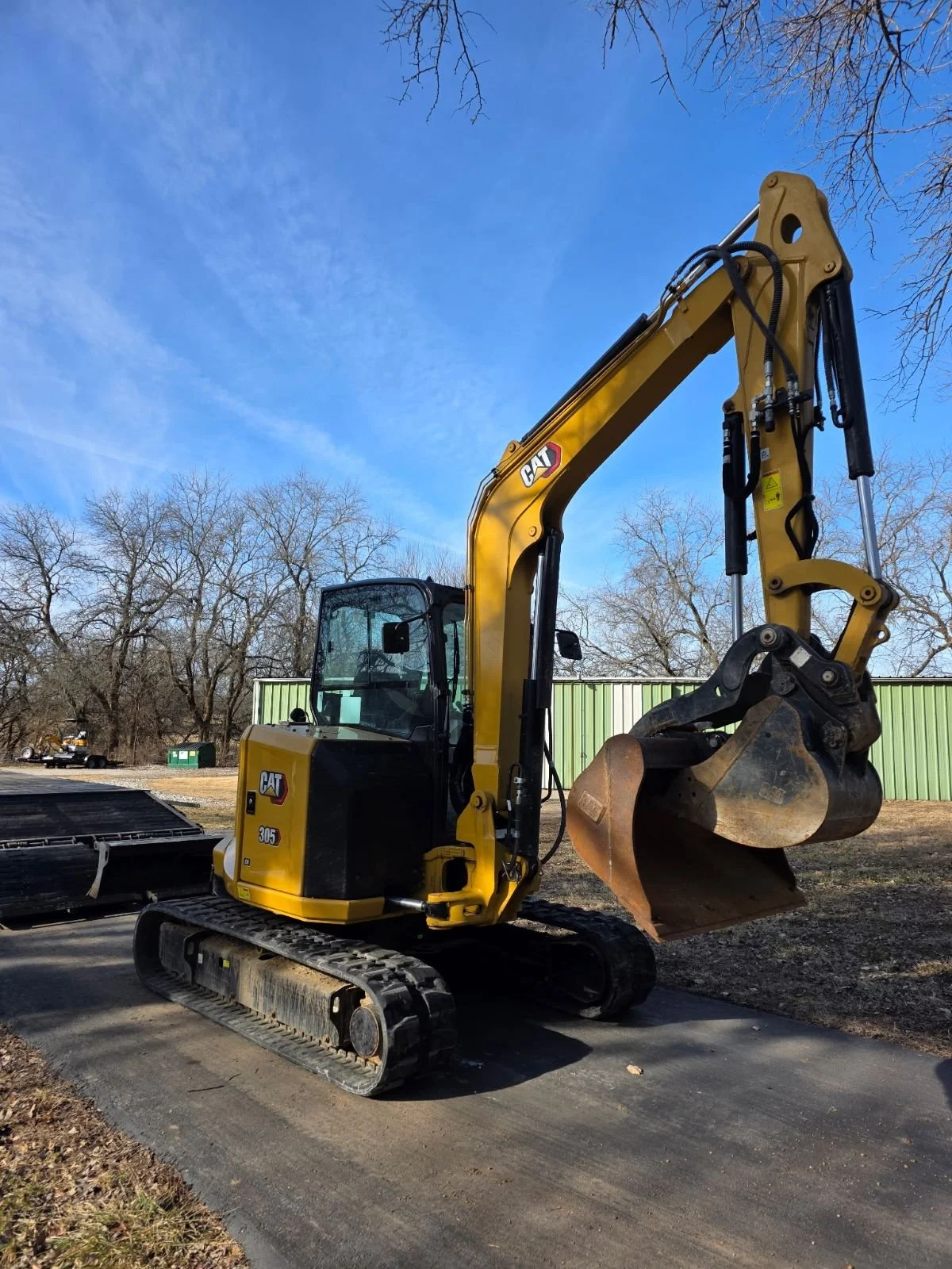 twin springs excavator in front of the shop