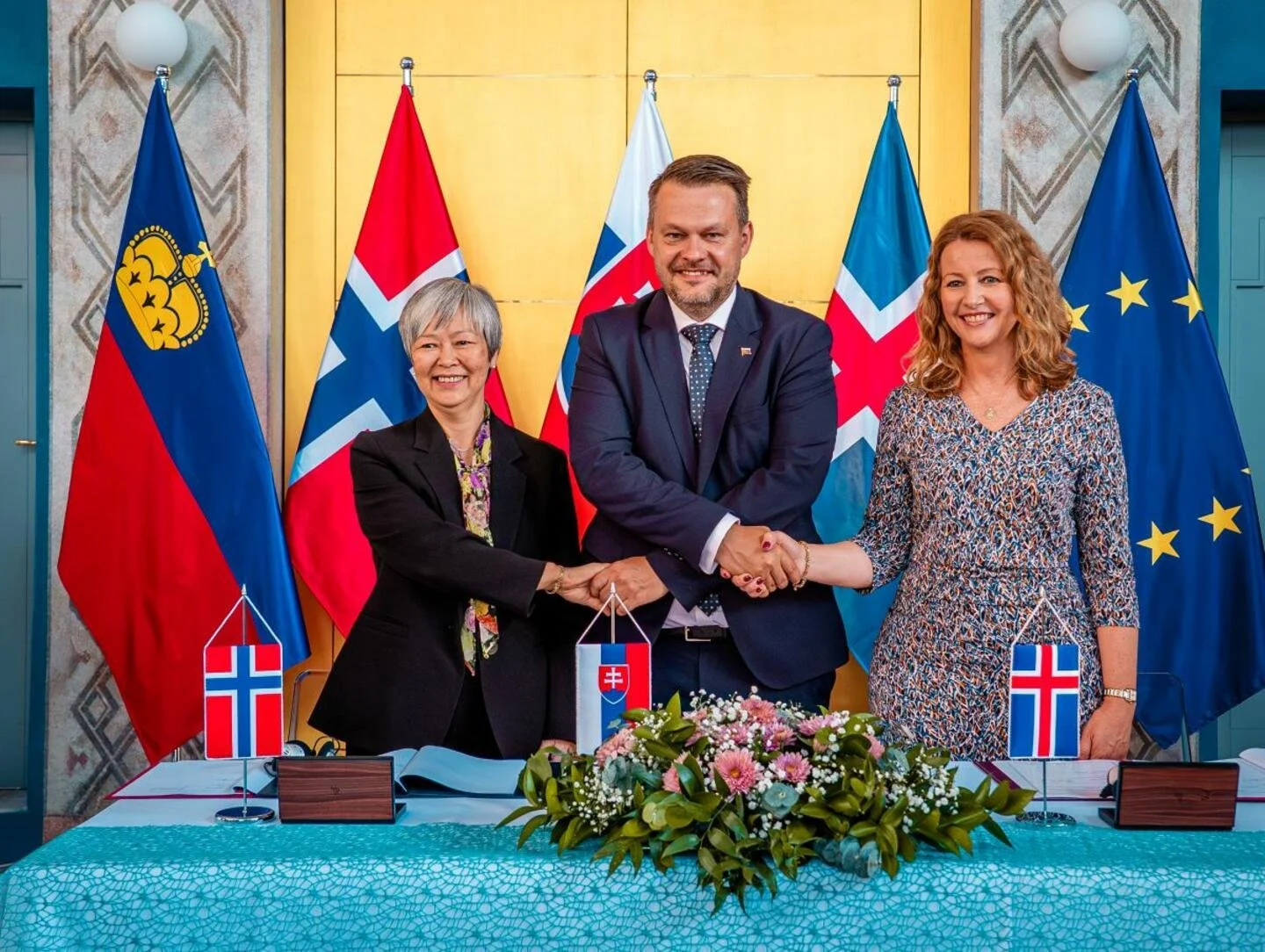 A picture of government officials shaking hands after signing a memorandum of understanding of new EEC grants period