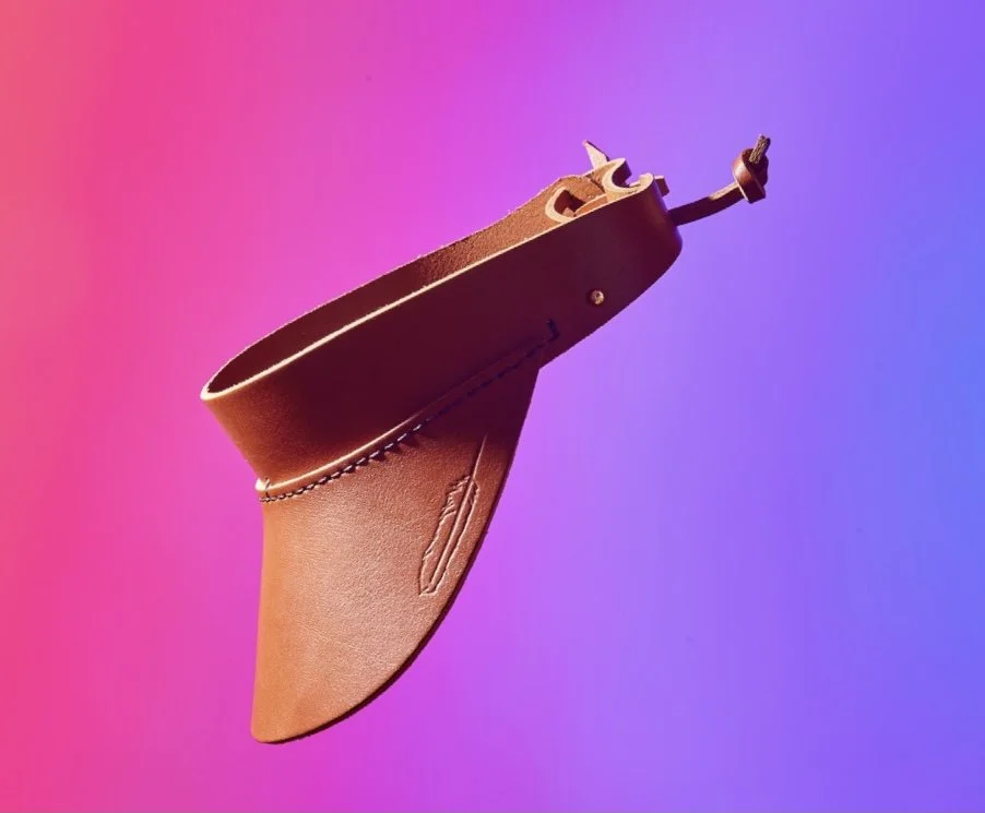 A brown leather holster with a gun inside, set against a pink and purple gradient background.