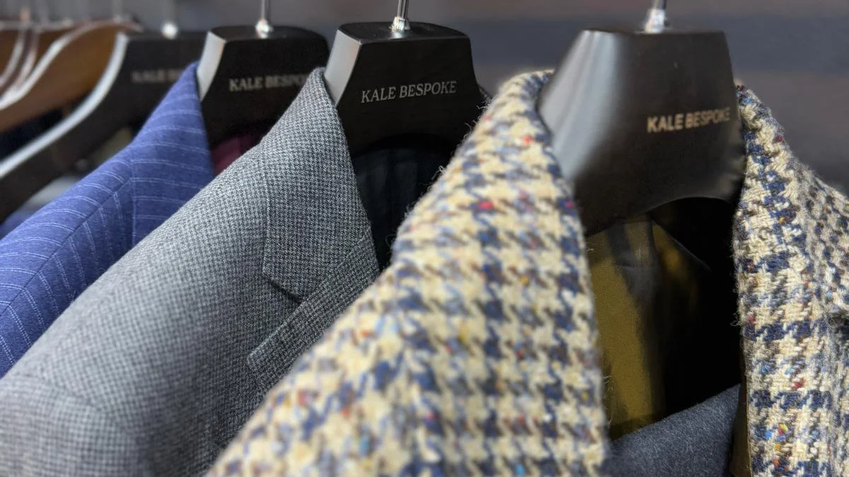 Bespoke jackets and suits on mannequins at Kale Bespoke tailor shop in the City of London