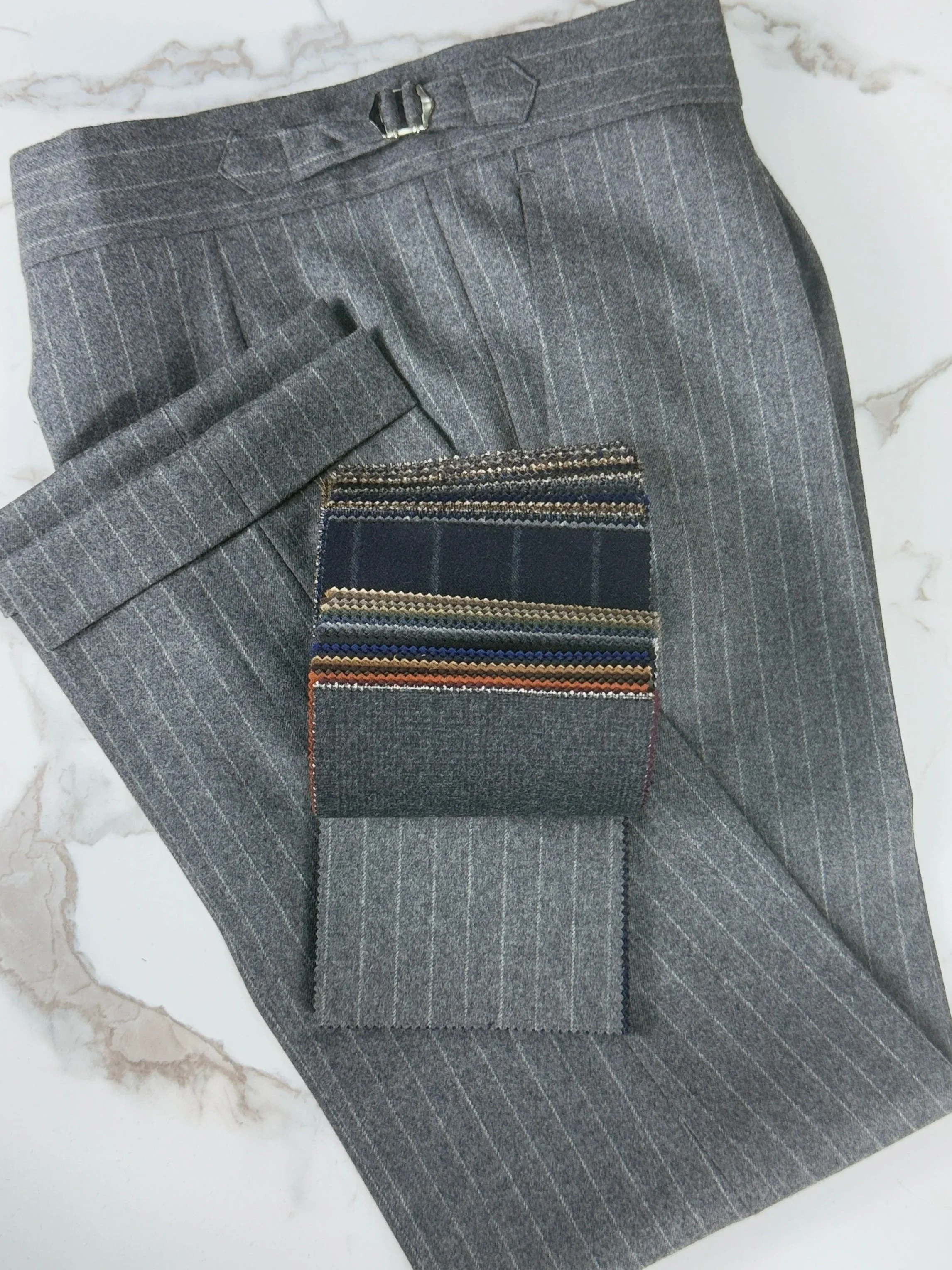Grey pinstripe flannel trousers with fox brother cloth book.