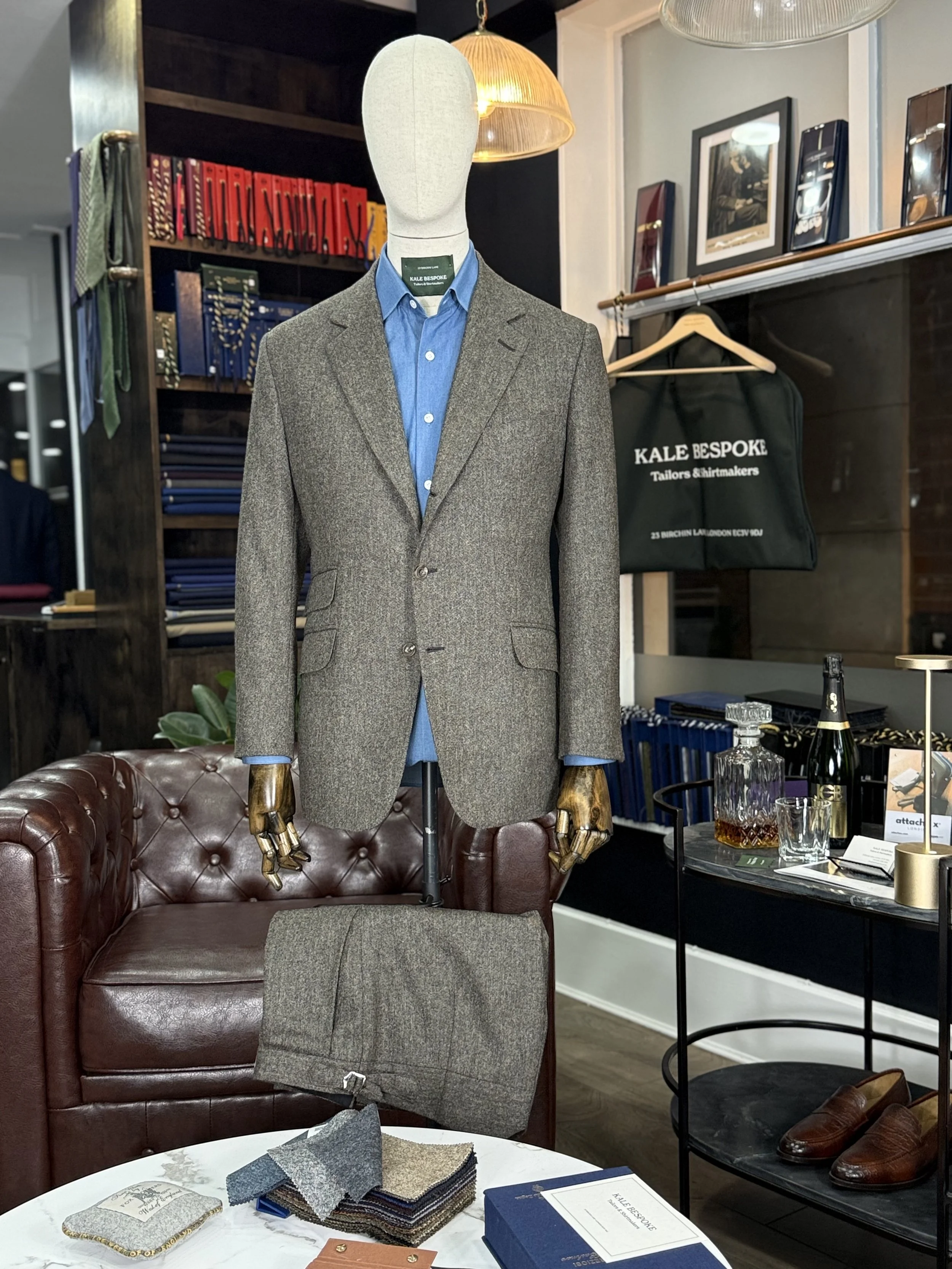 Brown mid-weight Donegal two-piece bespoke suit by Kale Bespoke Tailoring, handmade in London and showcased in our City of London showroom. Featuring a classic 3 roll 2 button jacket with slanted pockets and a ticket pocket, styled with a bespoke cha