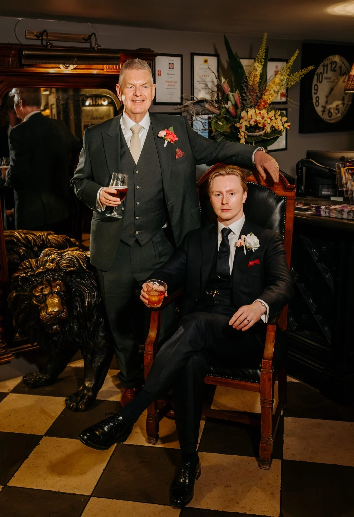Father and son wearing bespoke three piece wedding suits by Kale Bespoke, London. Classic navy and dark green mohair suits fabrics from Standeven mills, featuring waistcoats, silk pattern kale bespoke ties and bespoke shirts all created by Kale Bespo